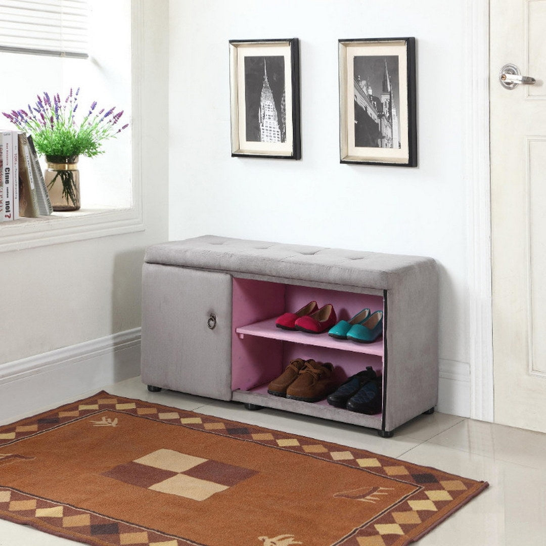 Grey tufted storage bench with pink shelves holding assorted shoes