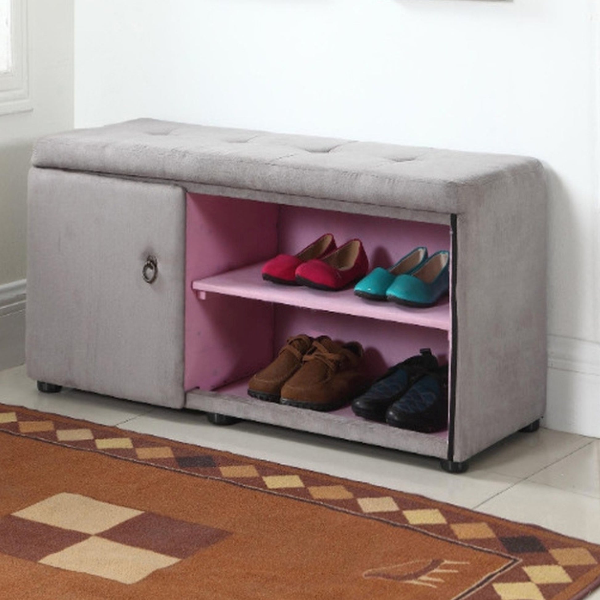 Grey velvet storage bench with tufted top and pink interior shoe rack