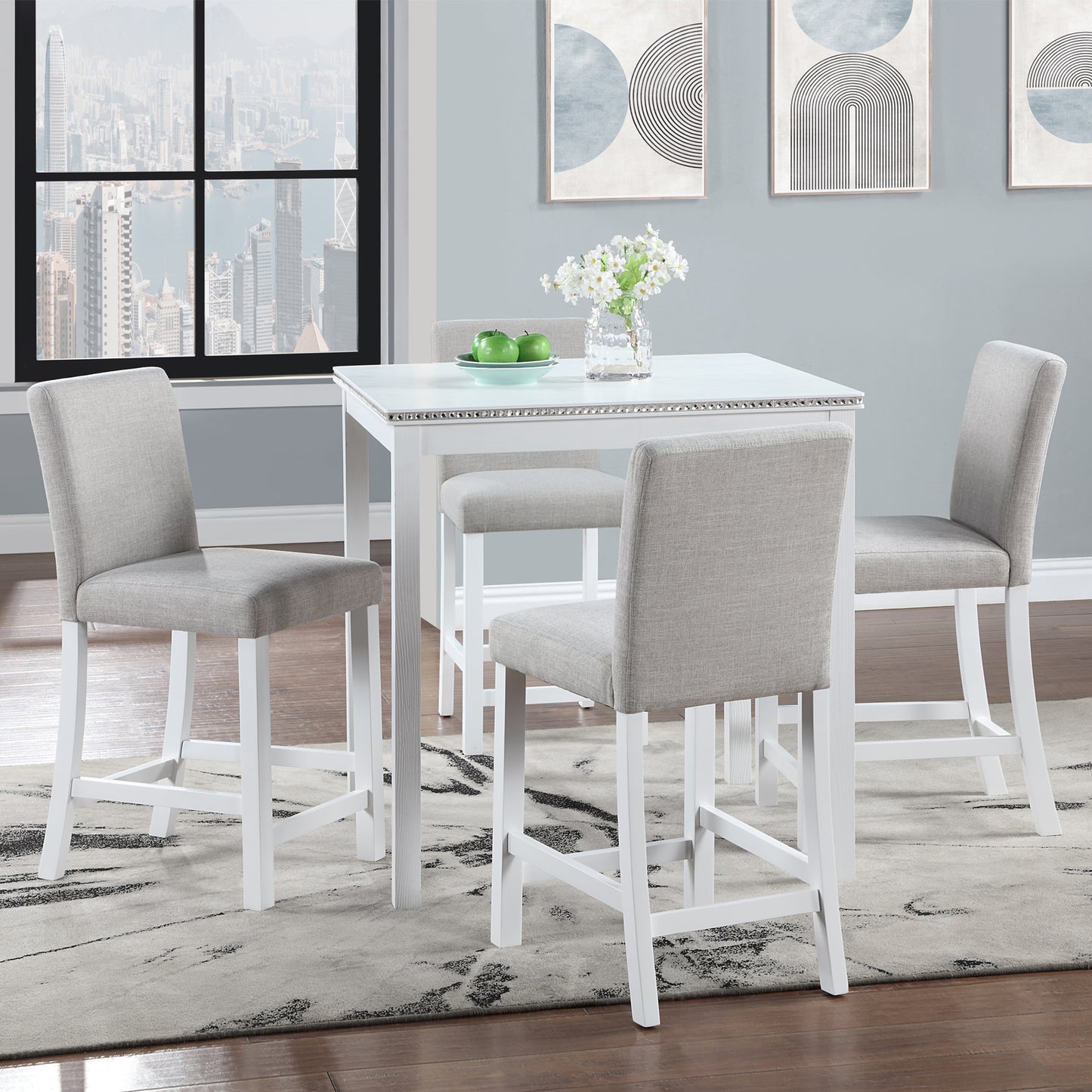 White counter height table with upholstered grey bar stools