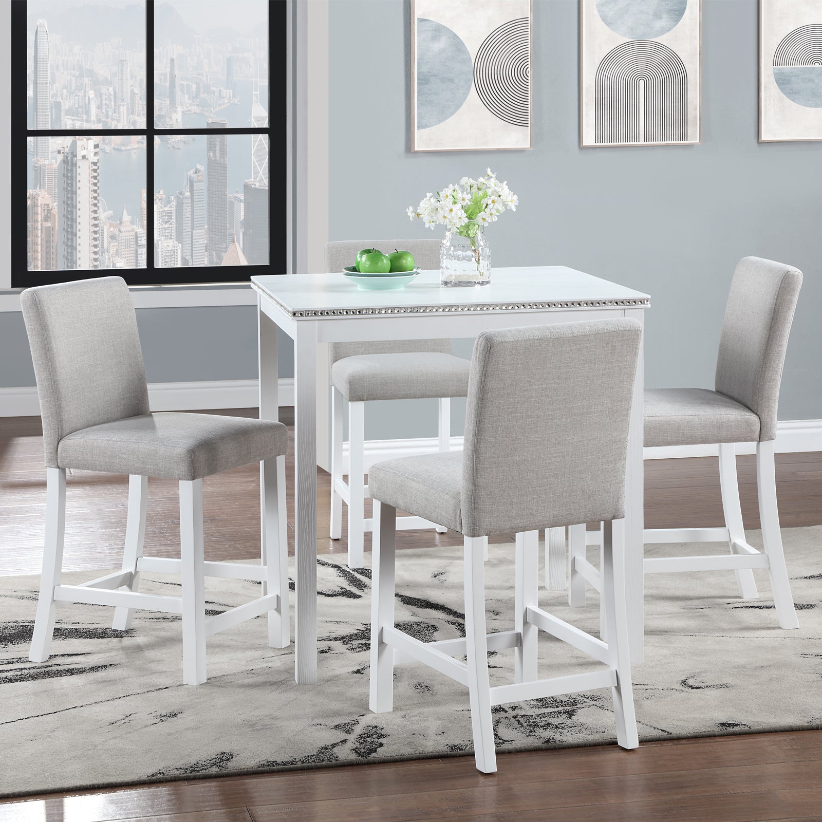 White counter height table with upholstered grey bar stools