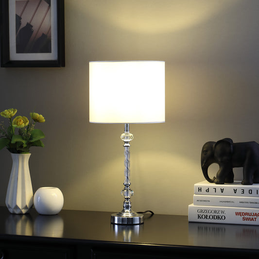 Elegant chrome table lamp with a white drum shade and crystal accents
