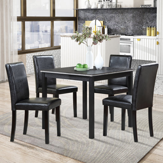 Black faux leather dining chairs with dark wood legs
