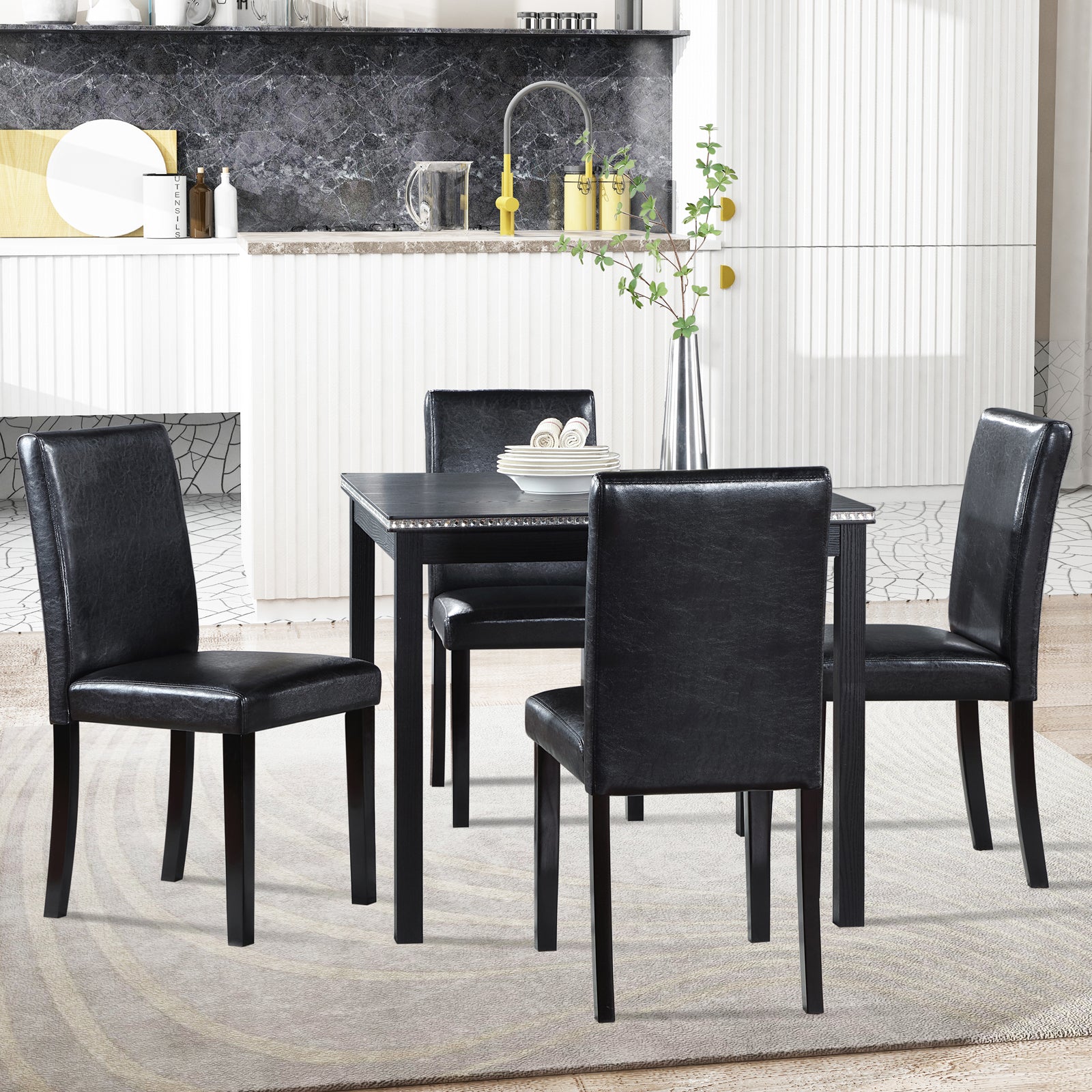 Black faux leather dining chairs with dark wood legs surrounding a black dining table