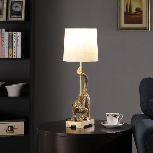 Golden monkey table lamp with a white fabric shade accenting a living room
