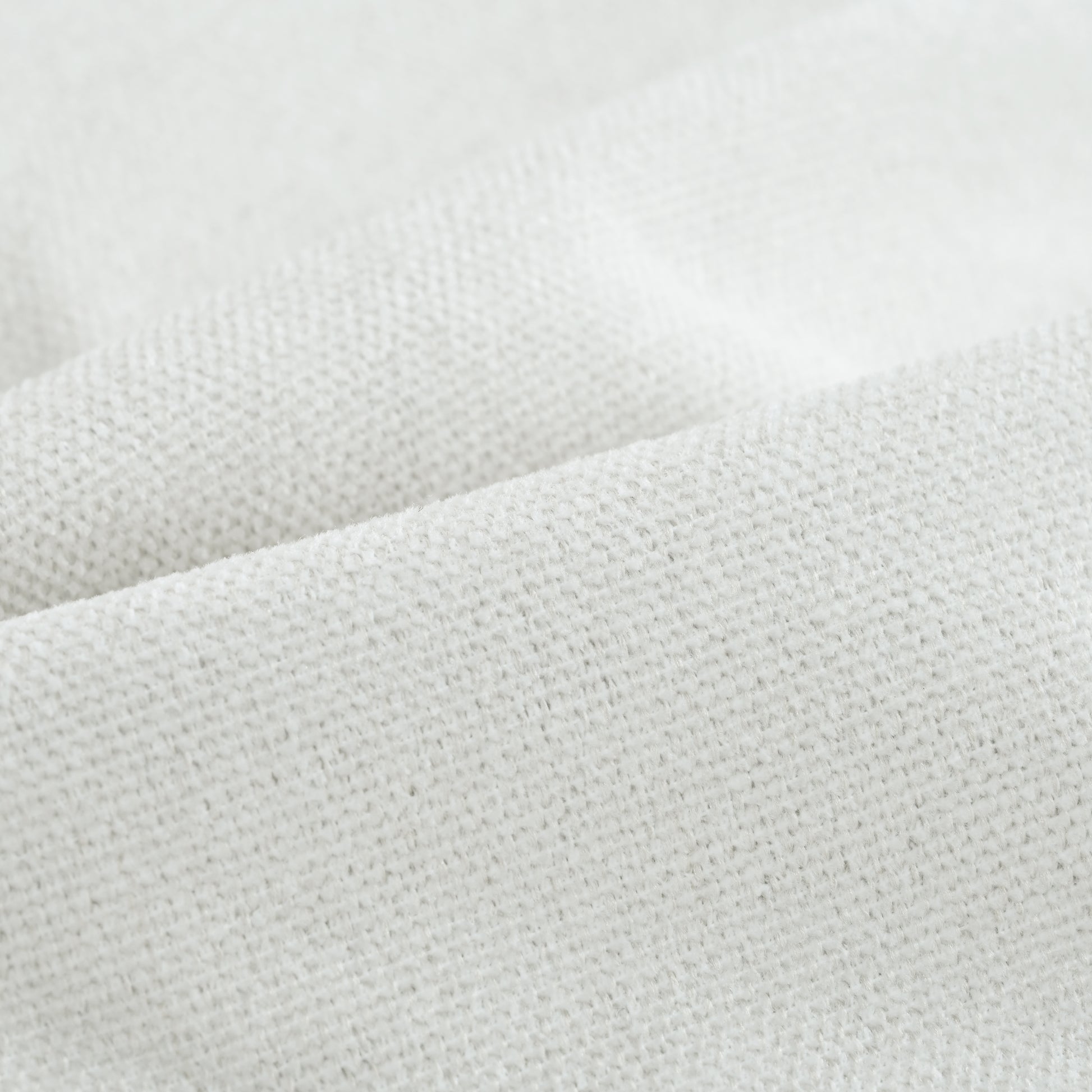 Closeup of a textured white linen fabric showcasing its natural fibers and weave for home decor
