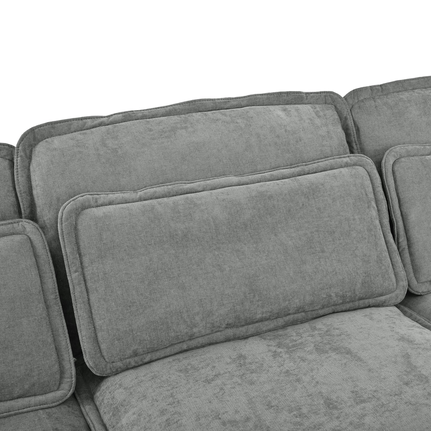 Closeup of plush grey fabric sofa with detailed stitching and soft cushions