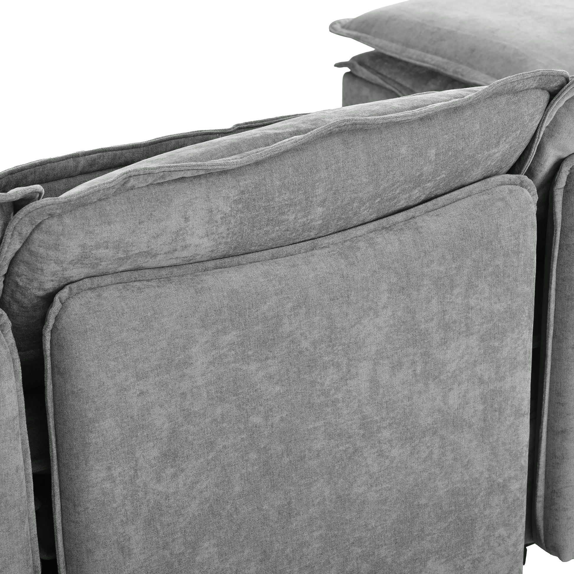 Closeup of plush grey fabric sofa with tufted back cushions for comfortable seating