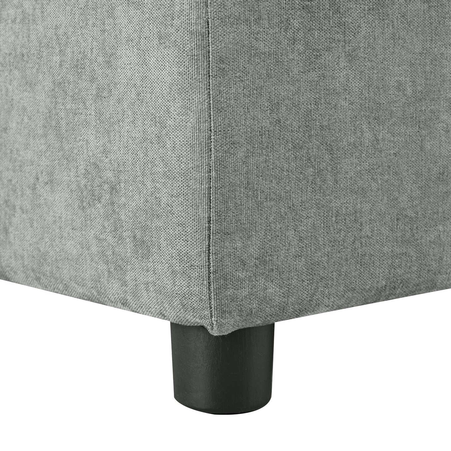 Closeup of textured grey fabric upholstery on a modern sofa leg