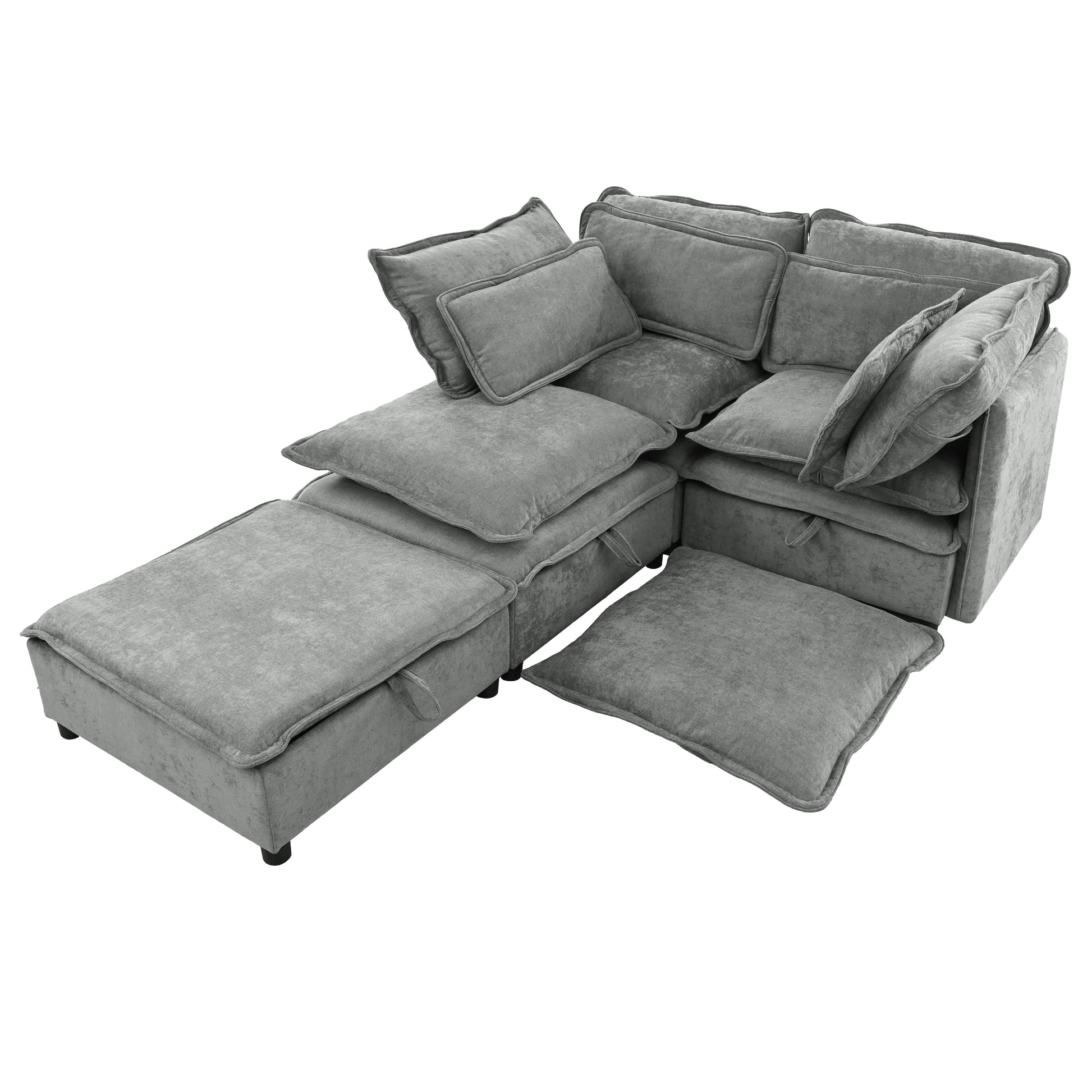 Modular grey velvet sectional sofa with plush cushions and a removable ottoman for versatile seating arrangements