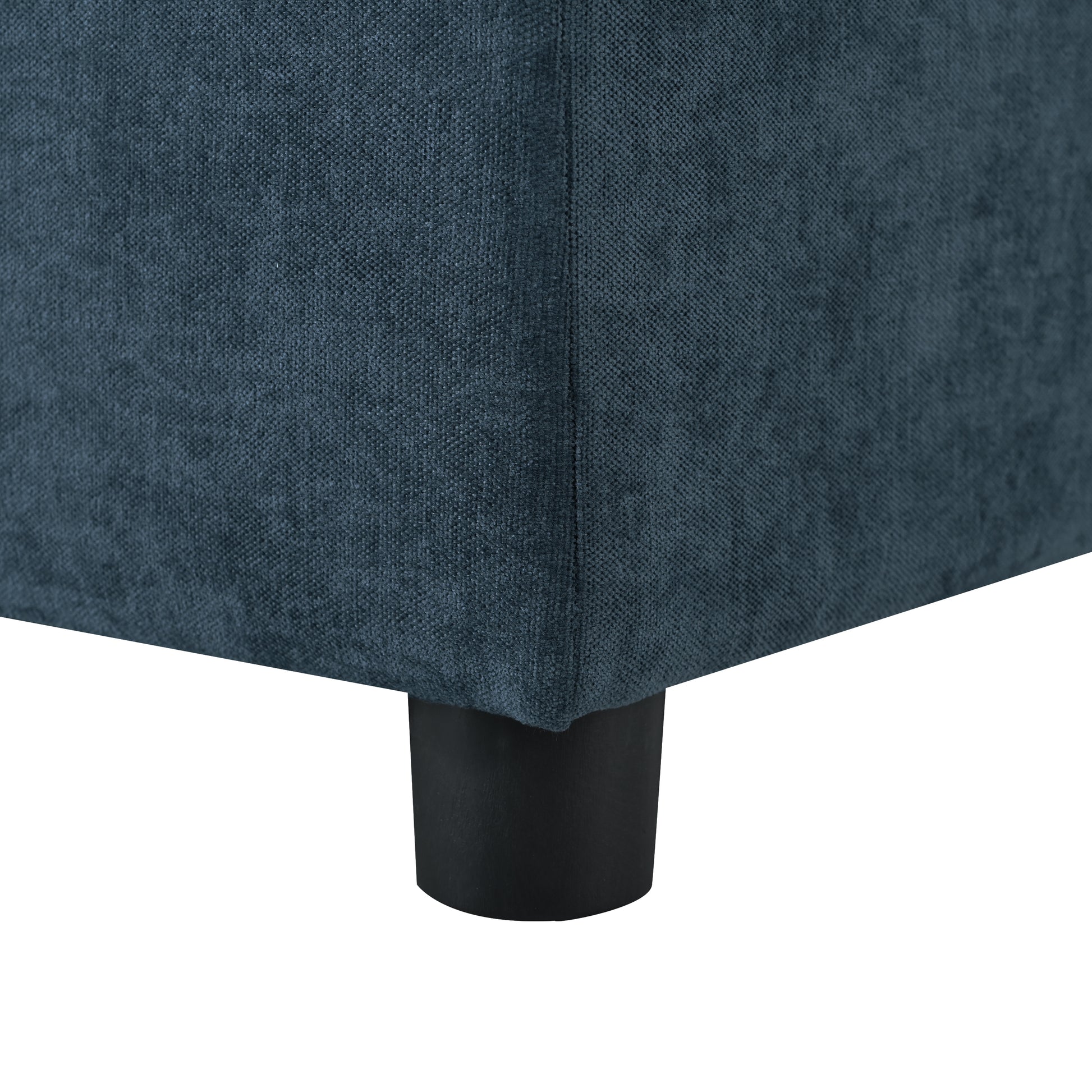 Dark teal fabric couch corner with a black cylindrical leg