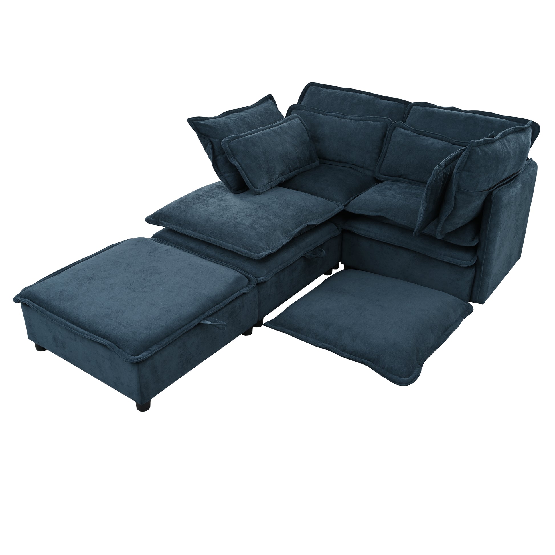 Plush deep teal sectional sofa with oversized pillows and a matching ottoman