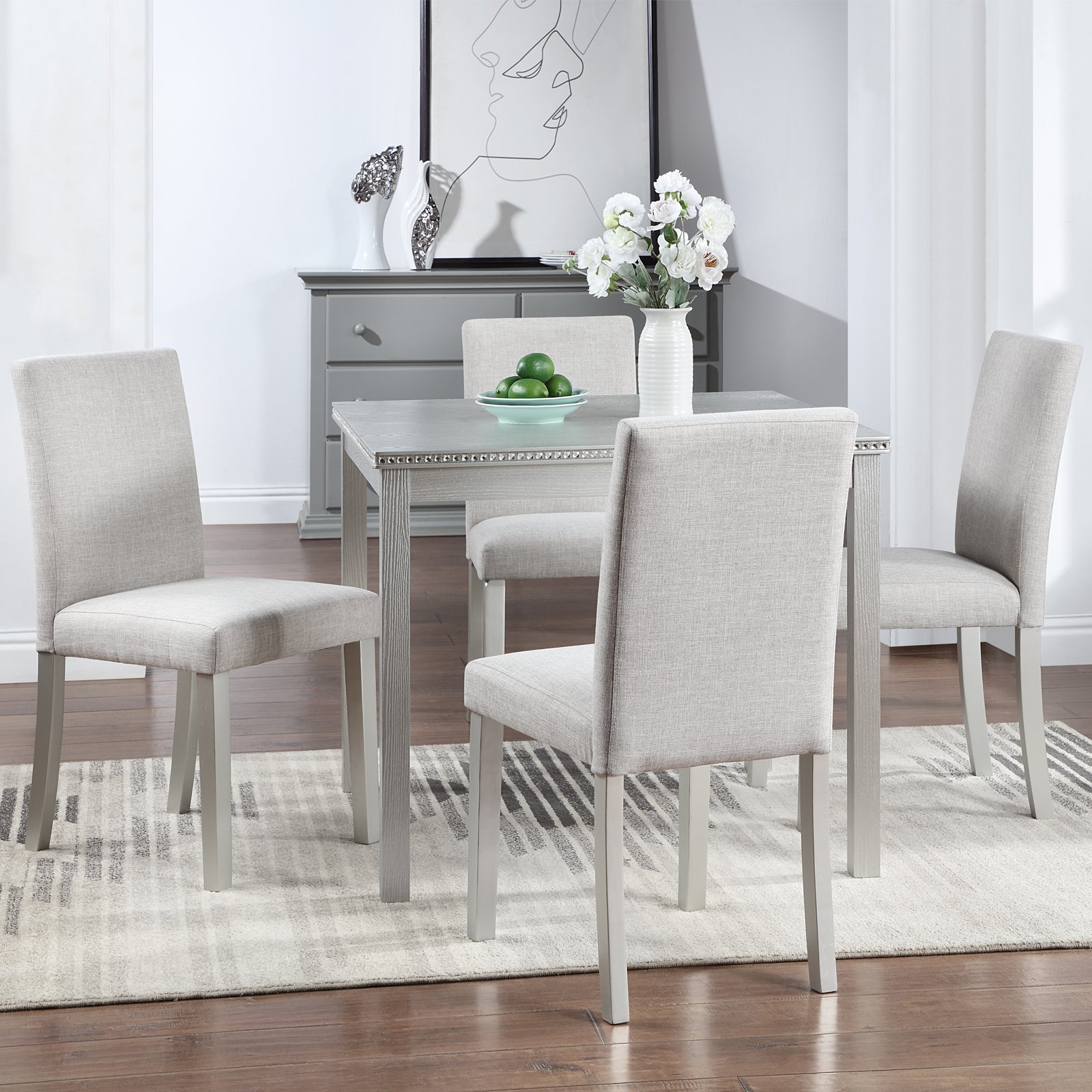 Gray upholstered dining chairs surrounding a light wood dining table set