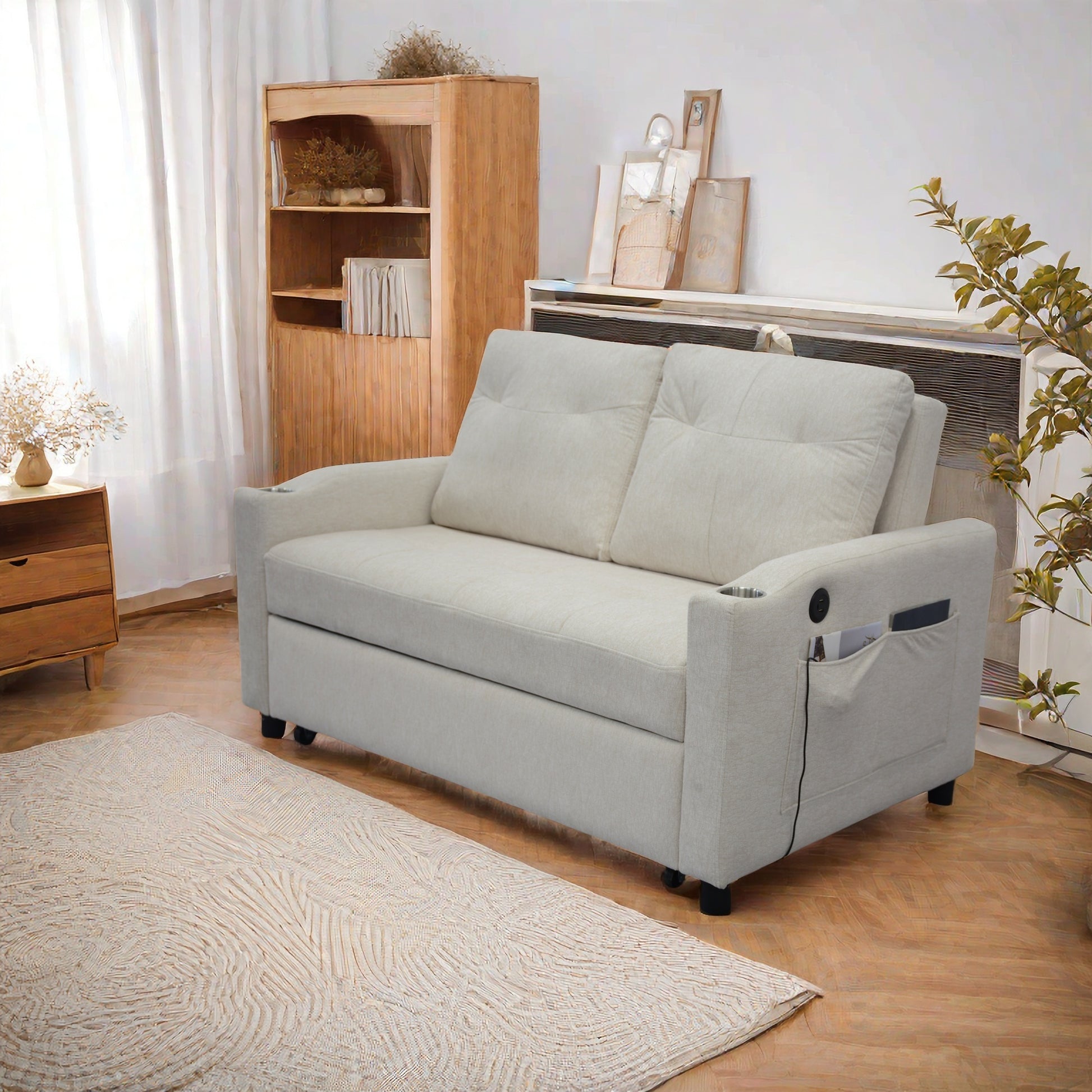 Light beige upholstered sofa bed with builtin side pockets and cup holders