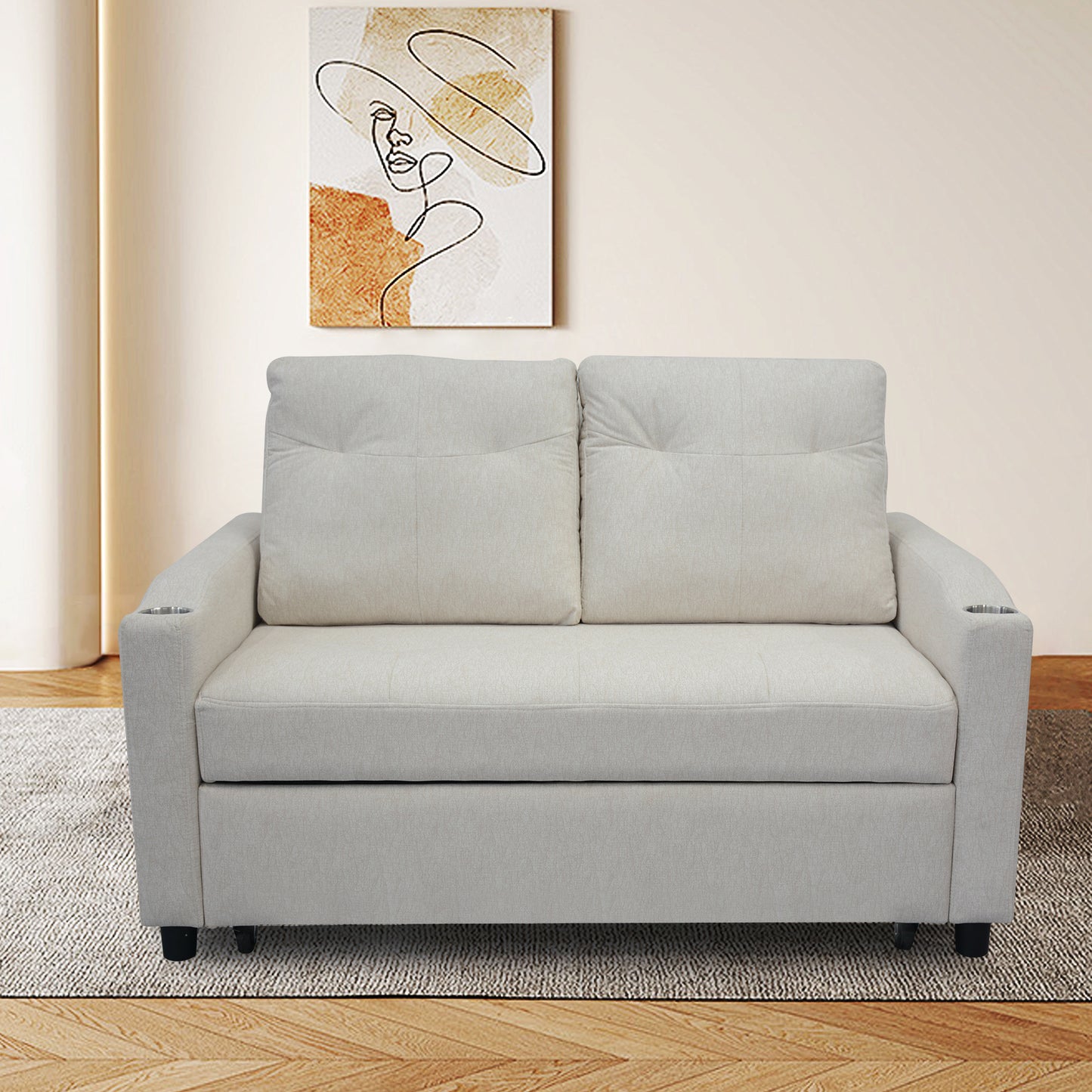 Light beige upholstered sofa with two pillows and builtin cup holders