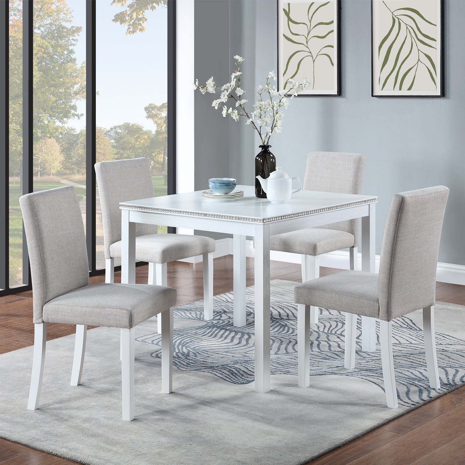 White square dining table with upholstered grey chairs