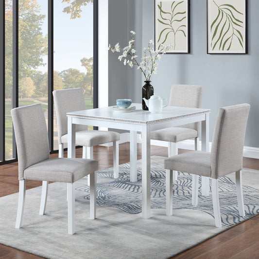 White square dining table with upholstered grey chairs