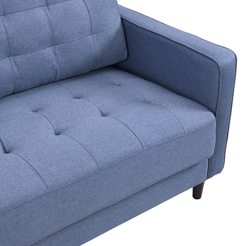 Tufted blue fabric sofa closeup showing comfortable seat cushions and armrest