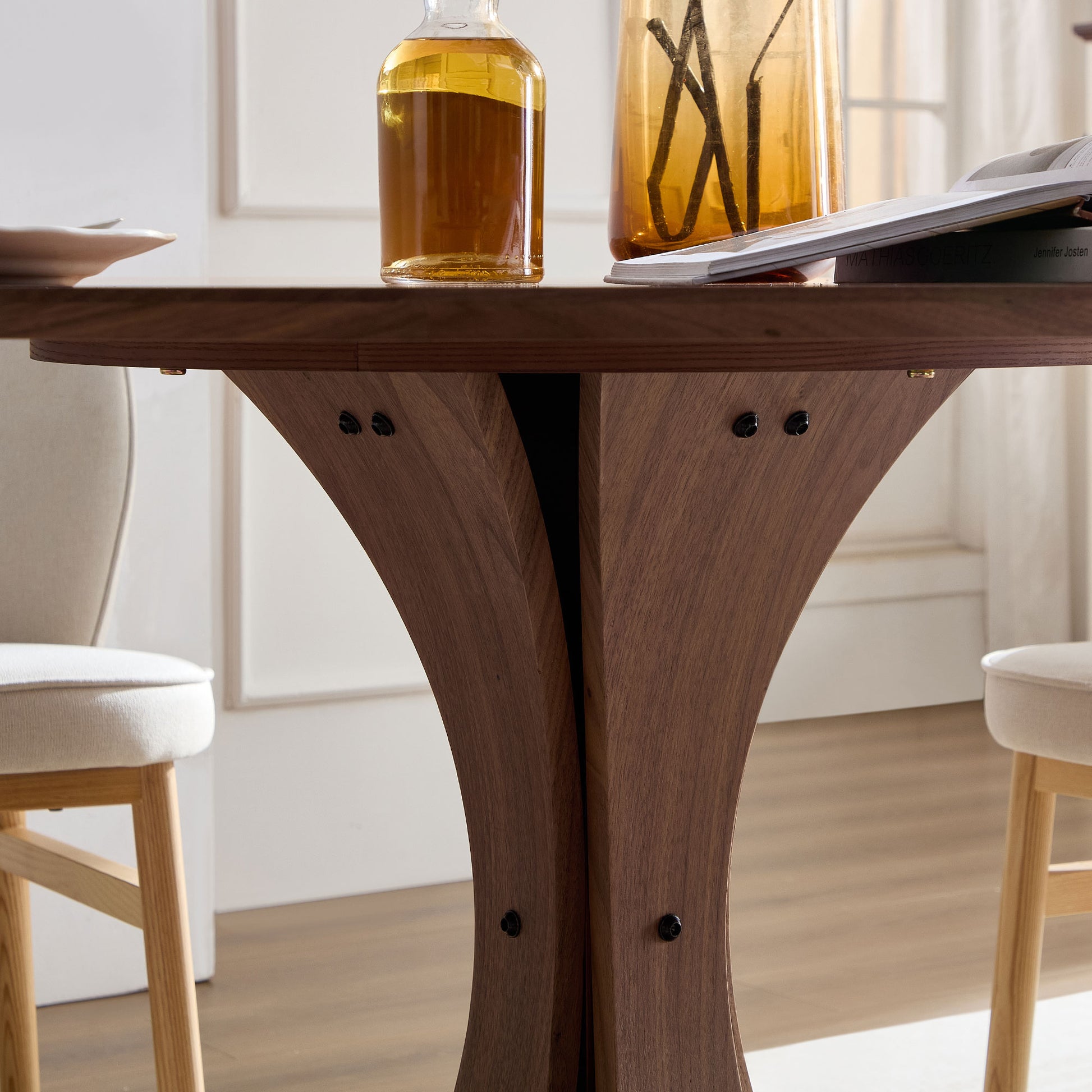 Solid wood dining table with a unique carved pedestal base and textured grain