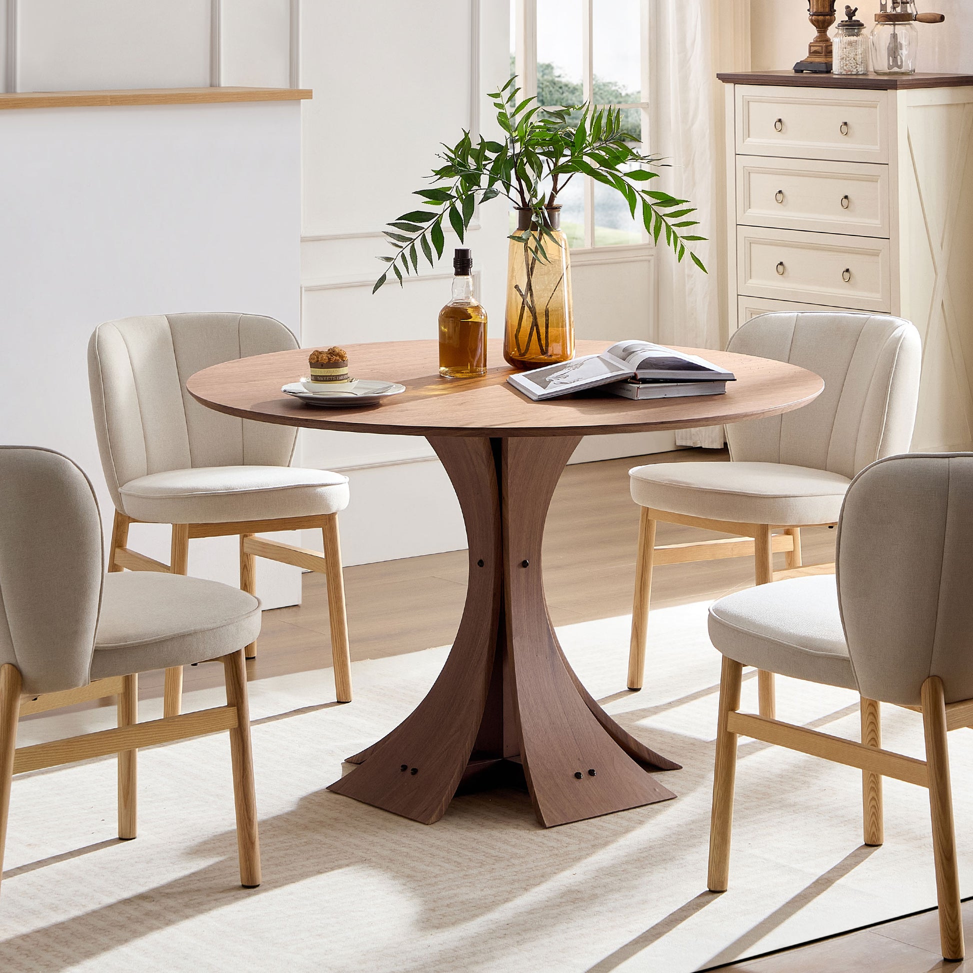 Modern round oak dining table with four upholstered chairs for a stylish dining room