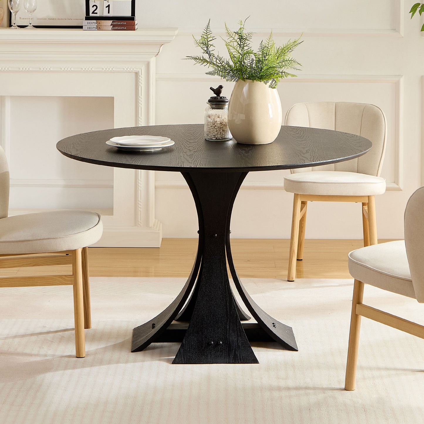 Black round dining table with a wood grain finish and sculptural base