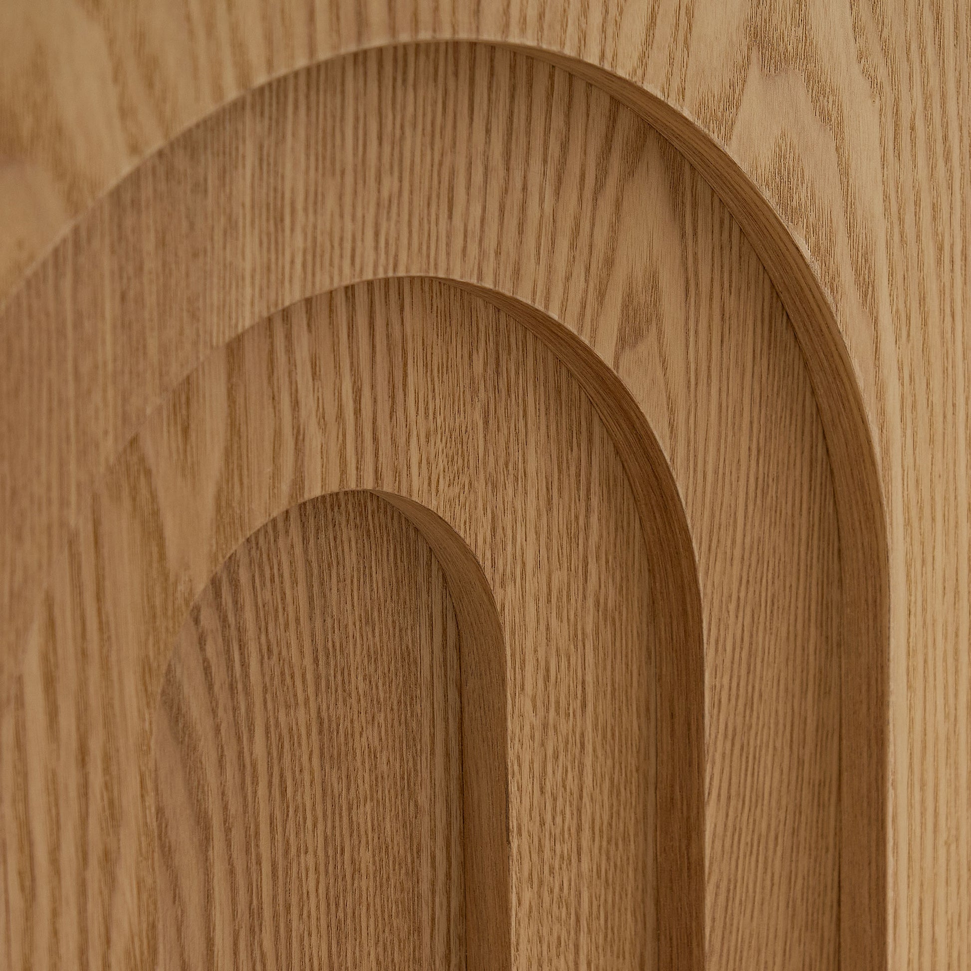 Textured natural oak wood paneling with layered arch design detail for modern interiors