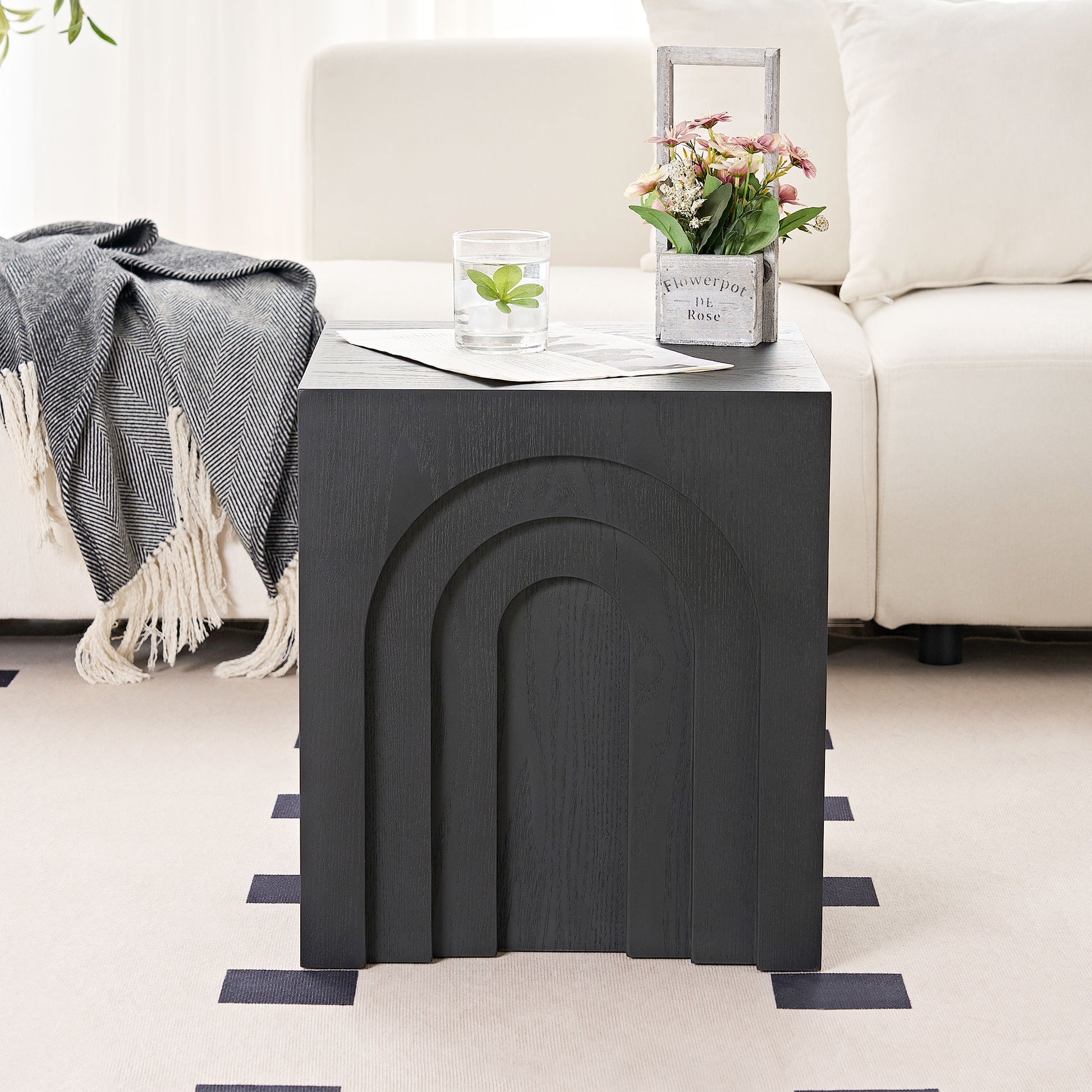 Black wooden side table with arched panel design