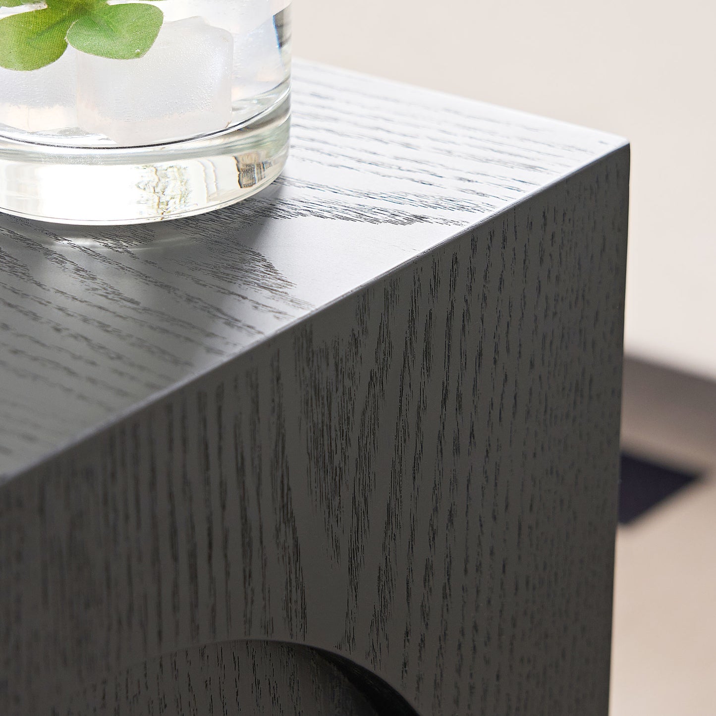 Modern black wood side table with textured finish and subtle grain detail