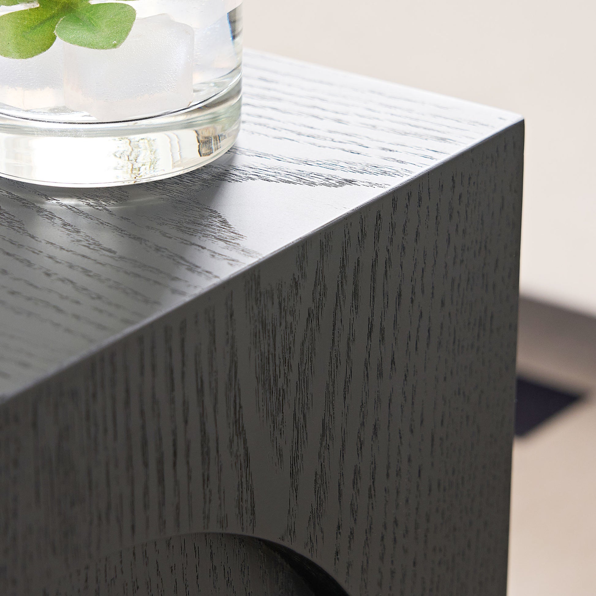 Modern black wood side table with textured finish and subtle grain detail