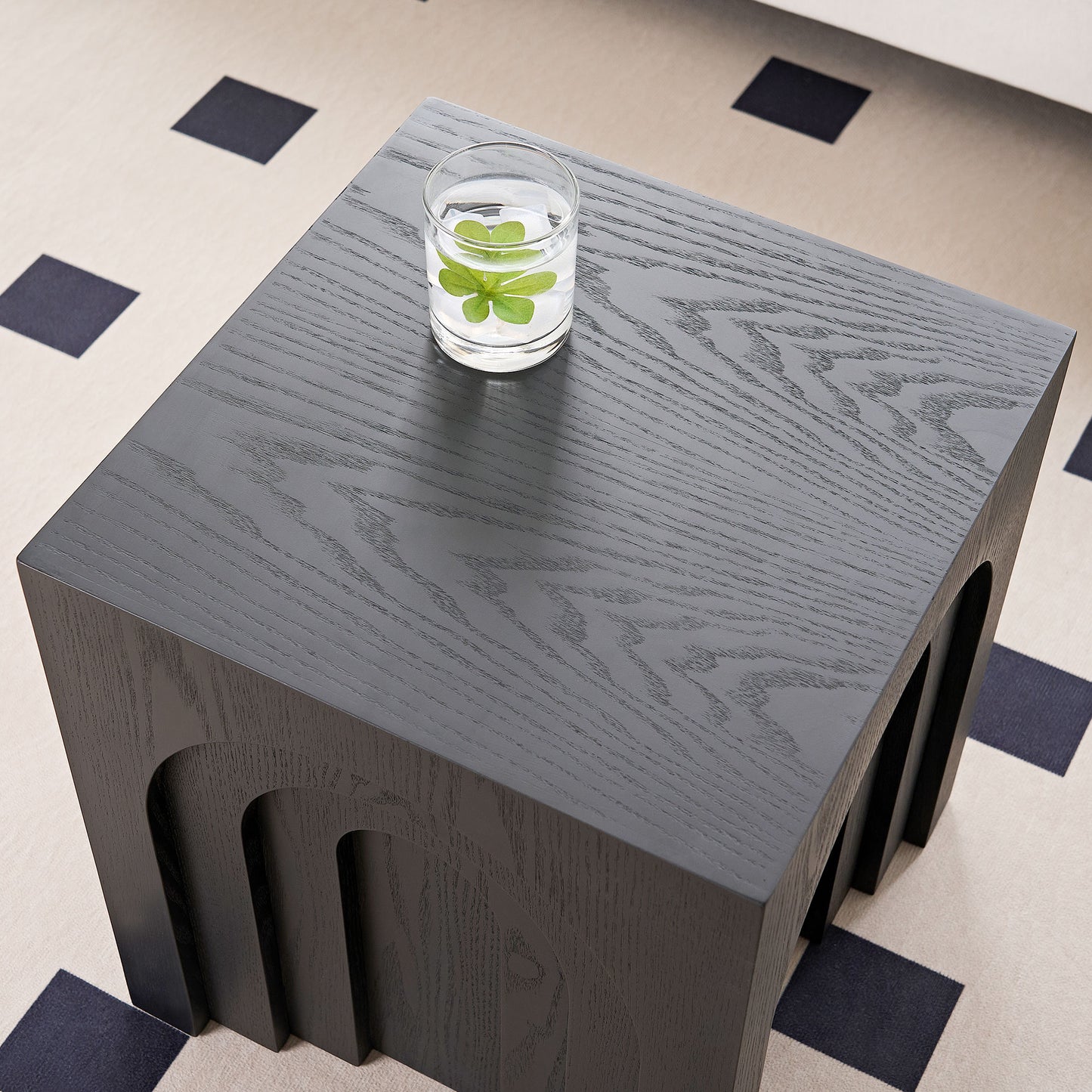 Dark grey wooden accent table with arched cutouts and natural wood grain texture