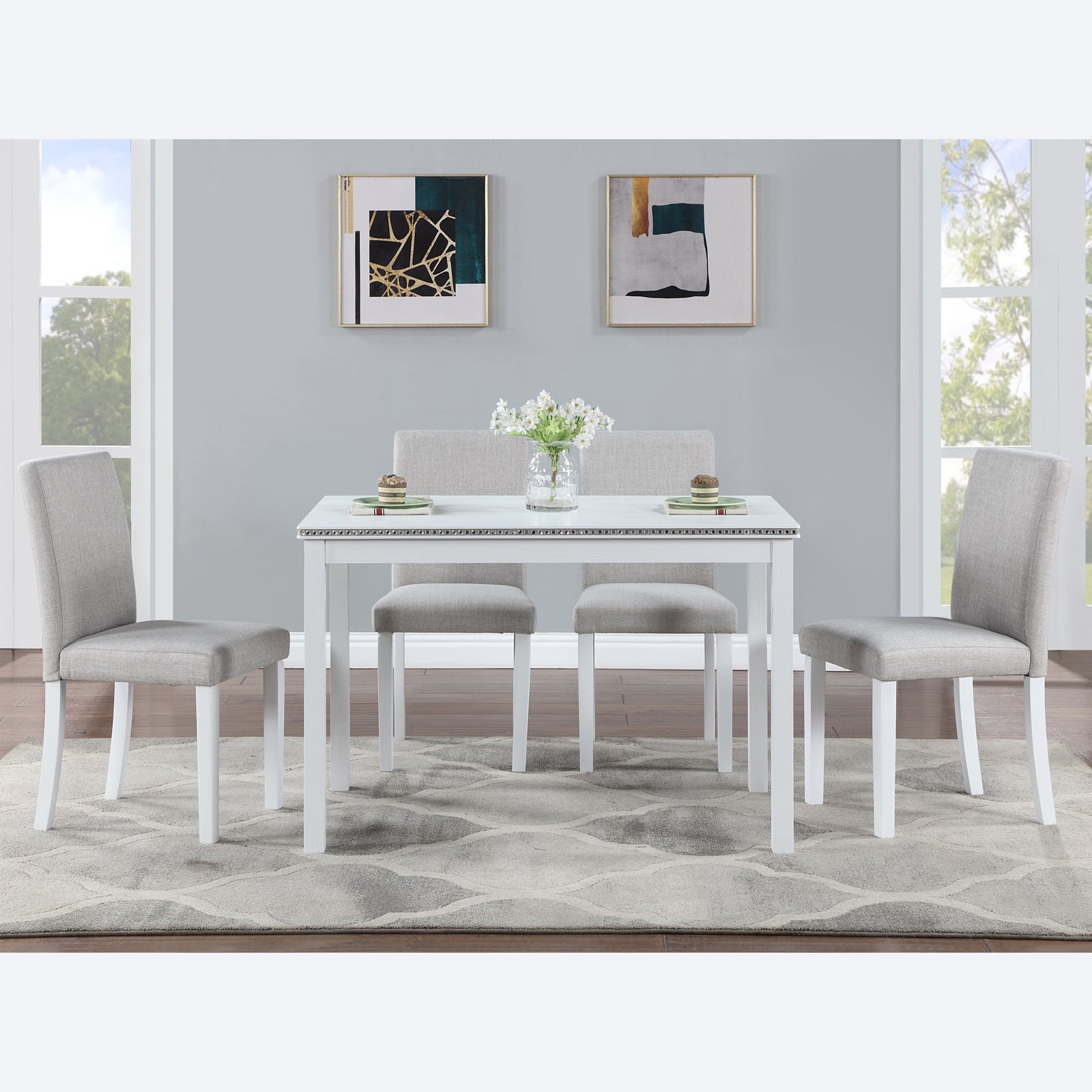 White modern dining table with four grey upholstered chairs