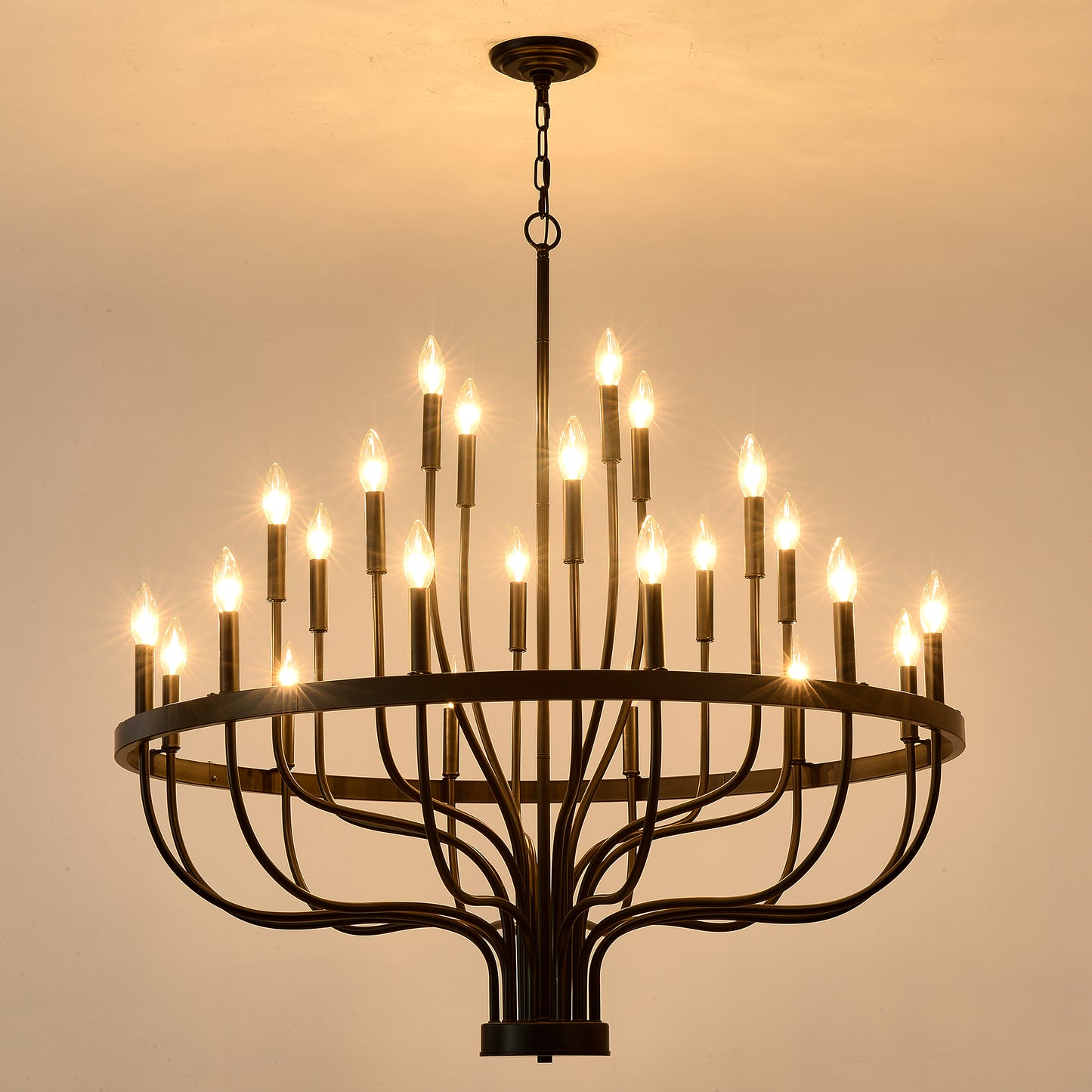 Black wrought iron chandelier with  candlestyle bulbs illuminating a warm room