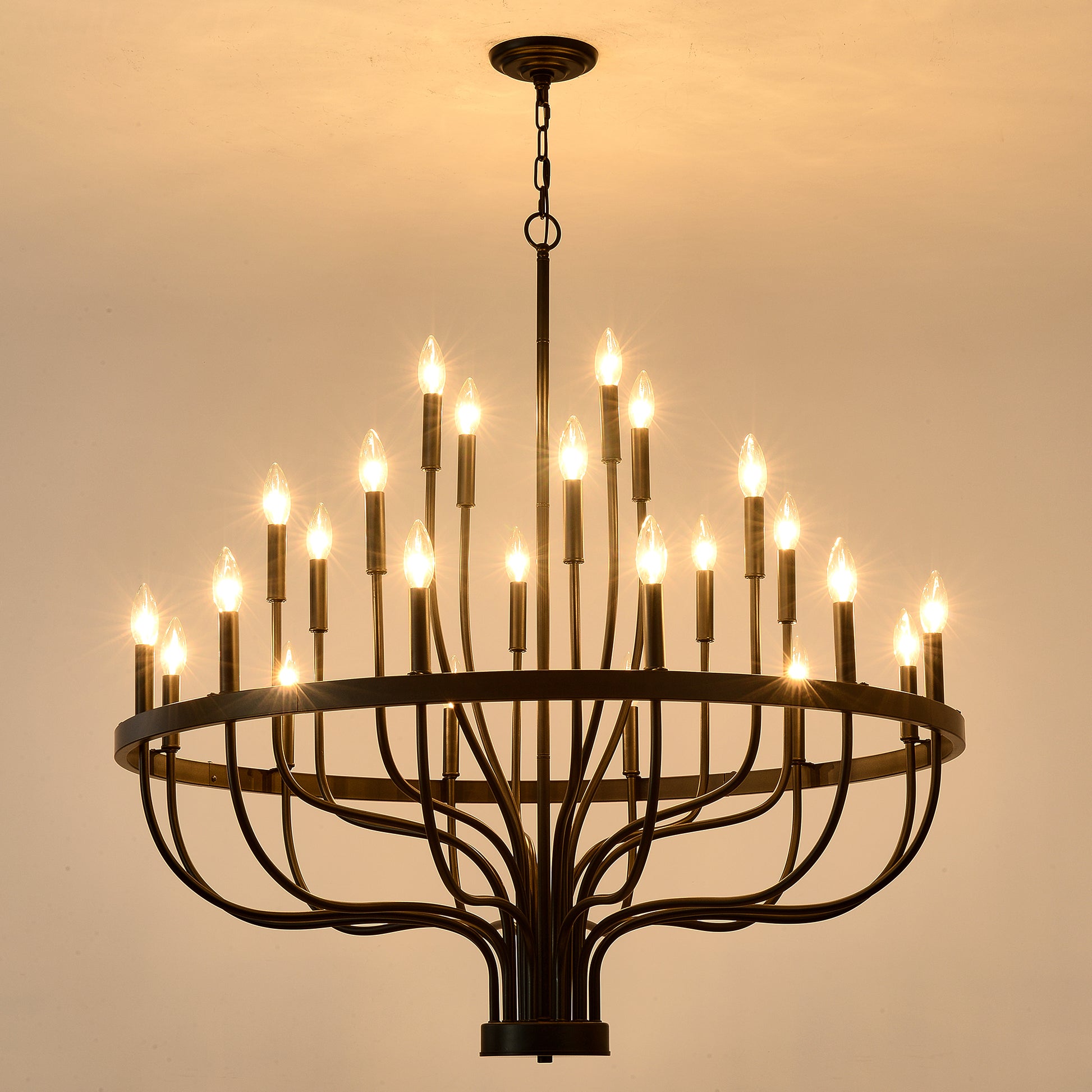 Black wrought iron chandelier with  candlestyle bulbs illuminating a warm room