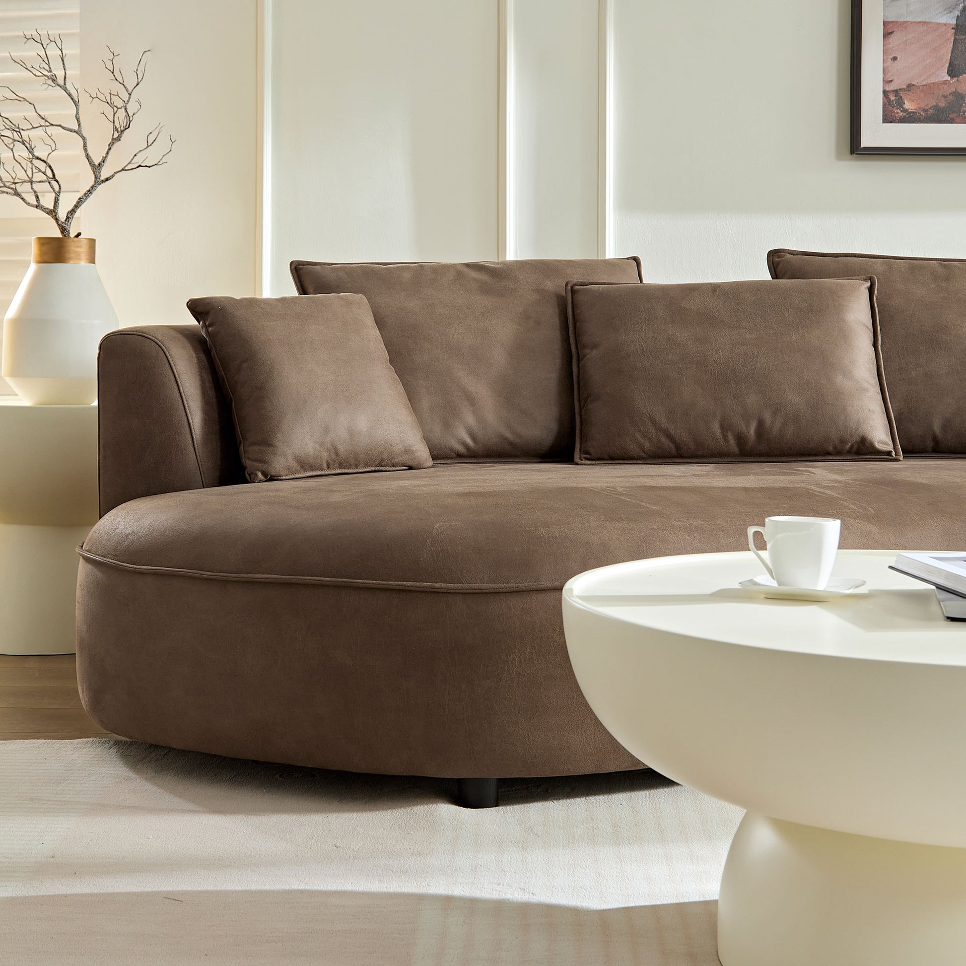 Curved brown sofa with plush cushions perfect for modern living rooms