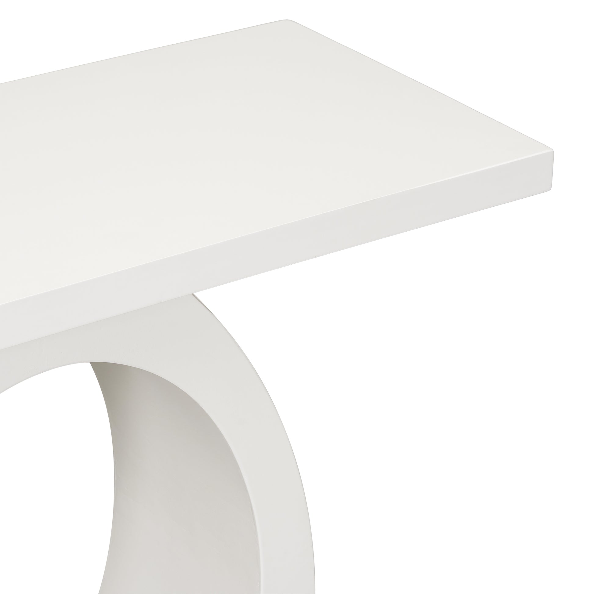 Closeup of a modern white console table with a curved pedestal base