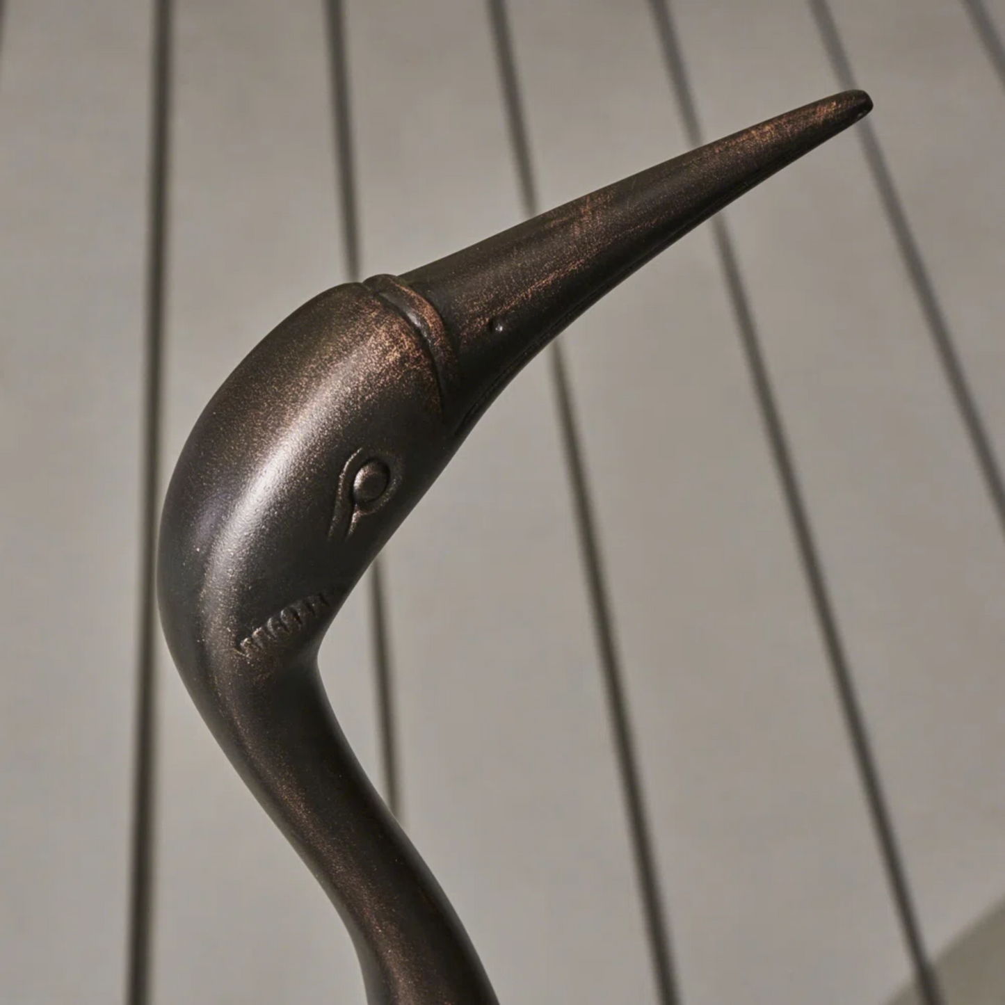 Bronze garden stake with crane silhouette and textured finish