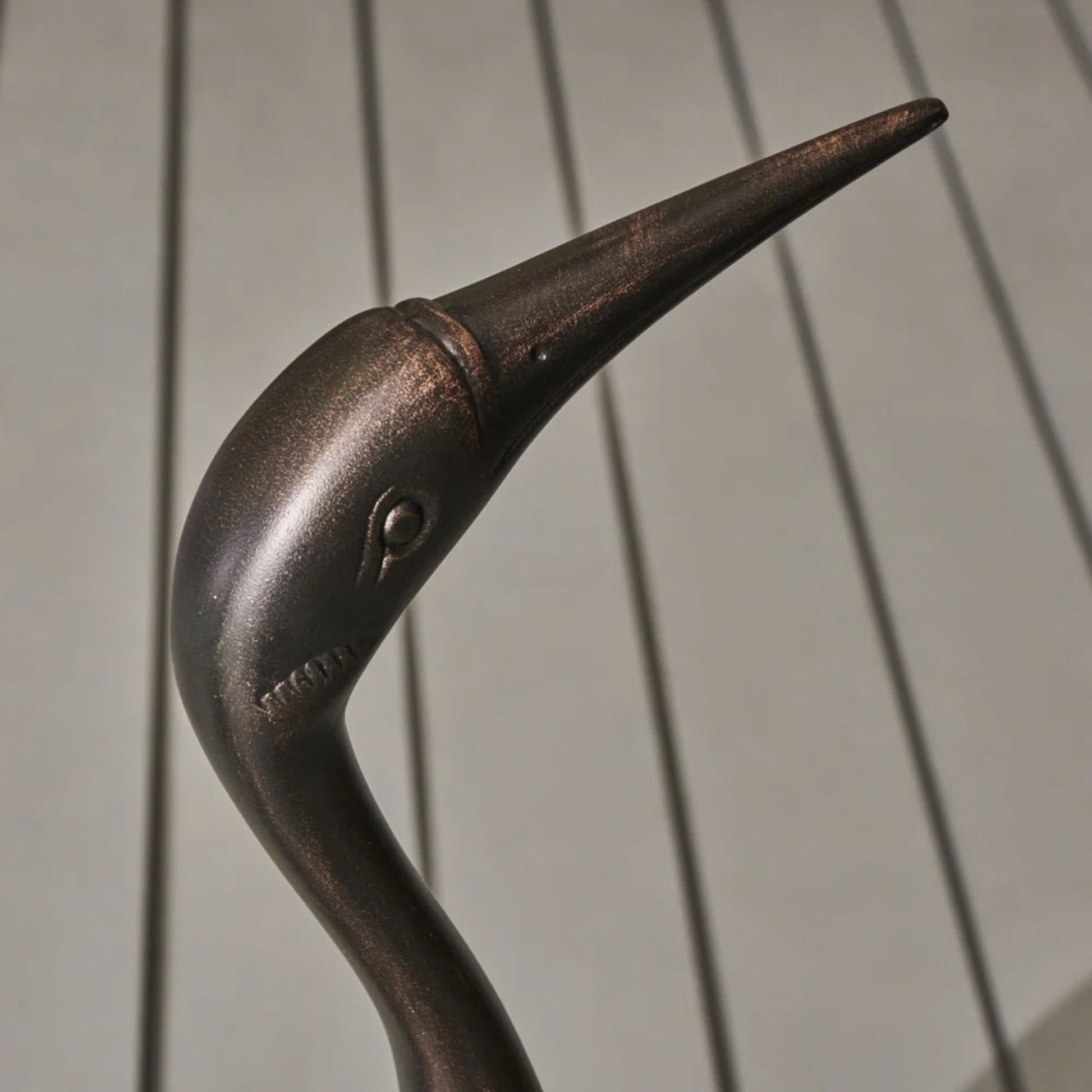 Bronze garden stake with crane silhouette and textured finish