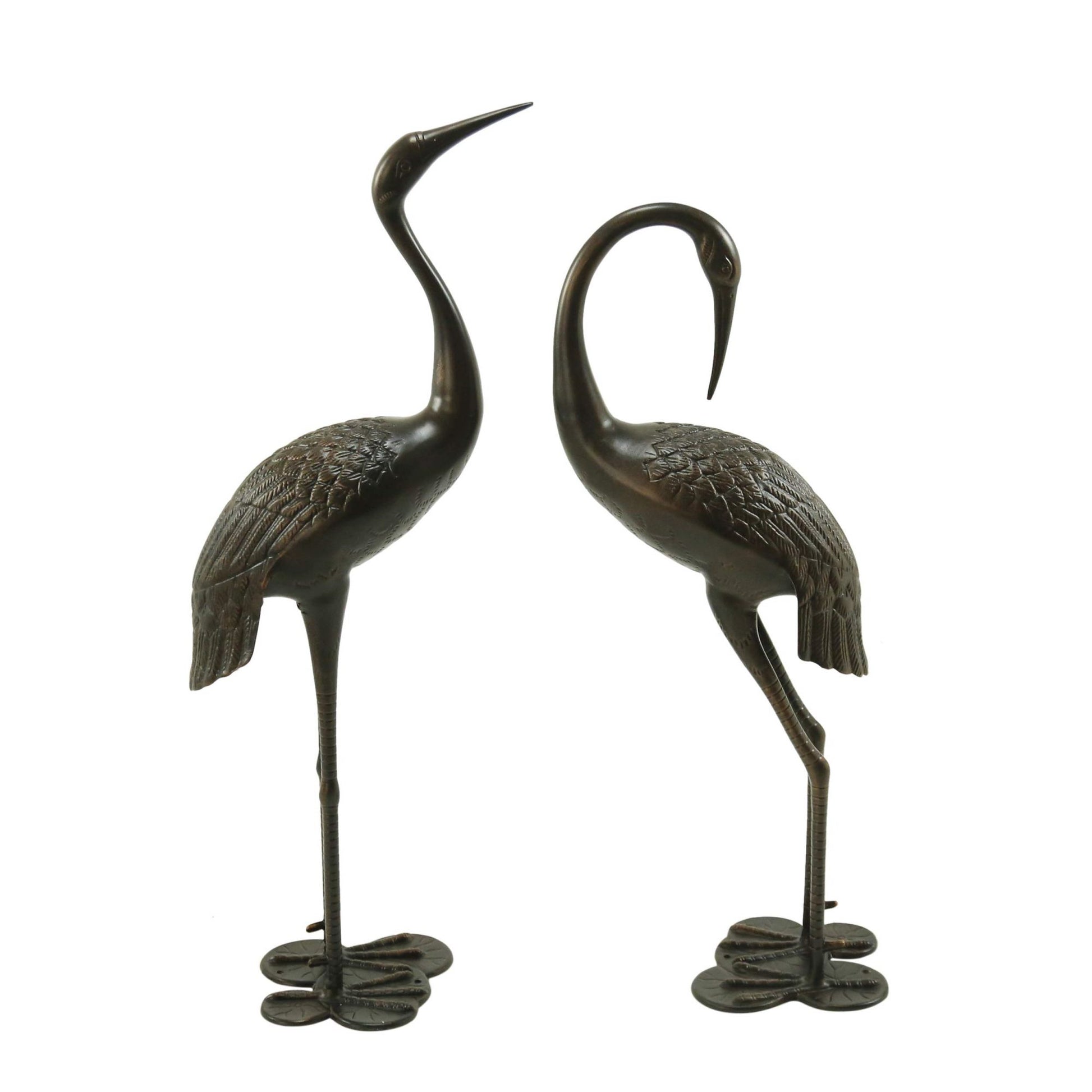 Two antique bronze crane statues with detailed feathering and delicate legs