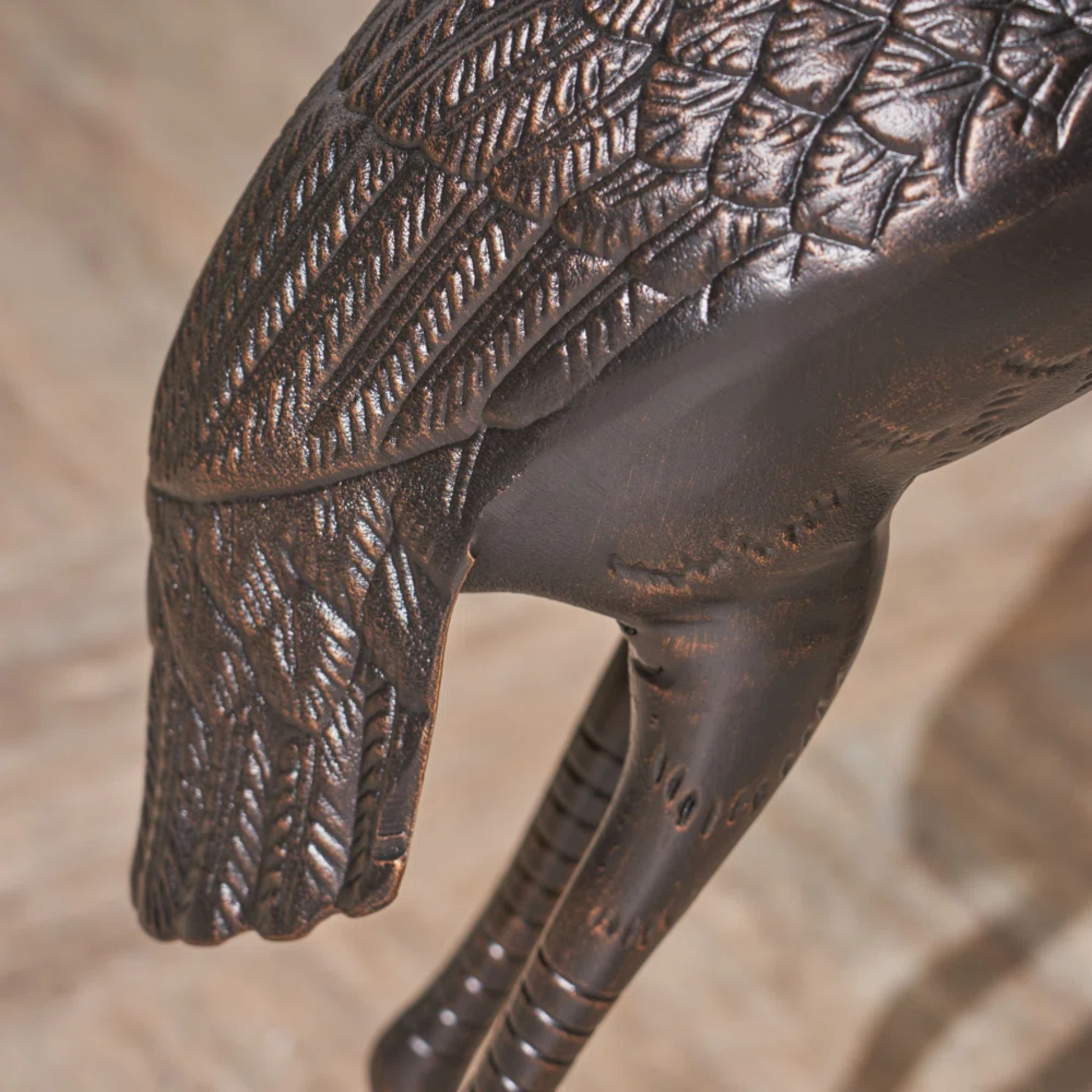 Bronze garden statue of a crane showing detailed feather texture