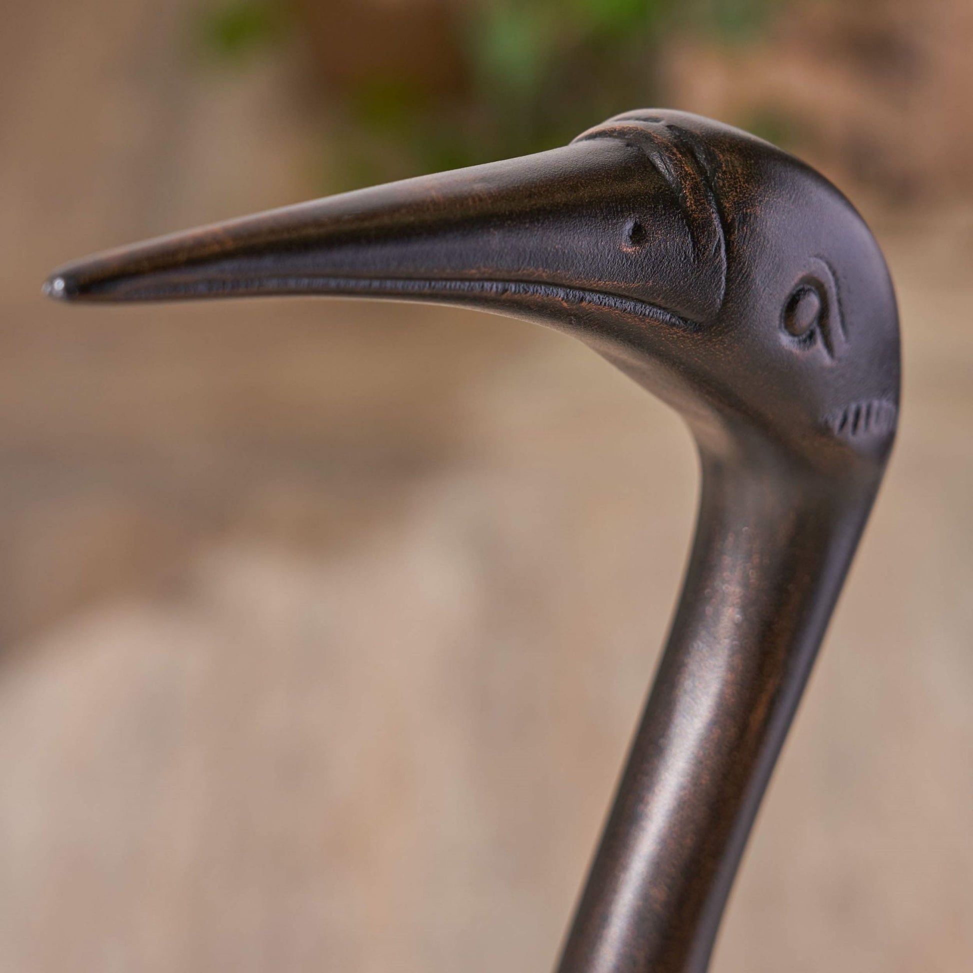 Bronze bird garden stake with weathered finish