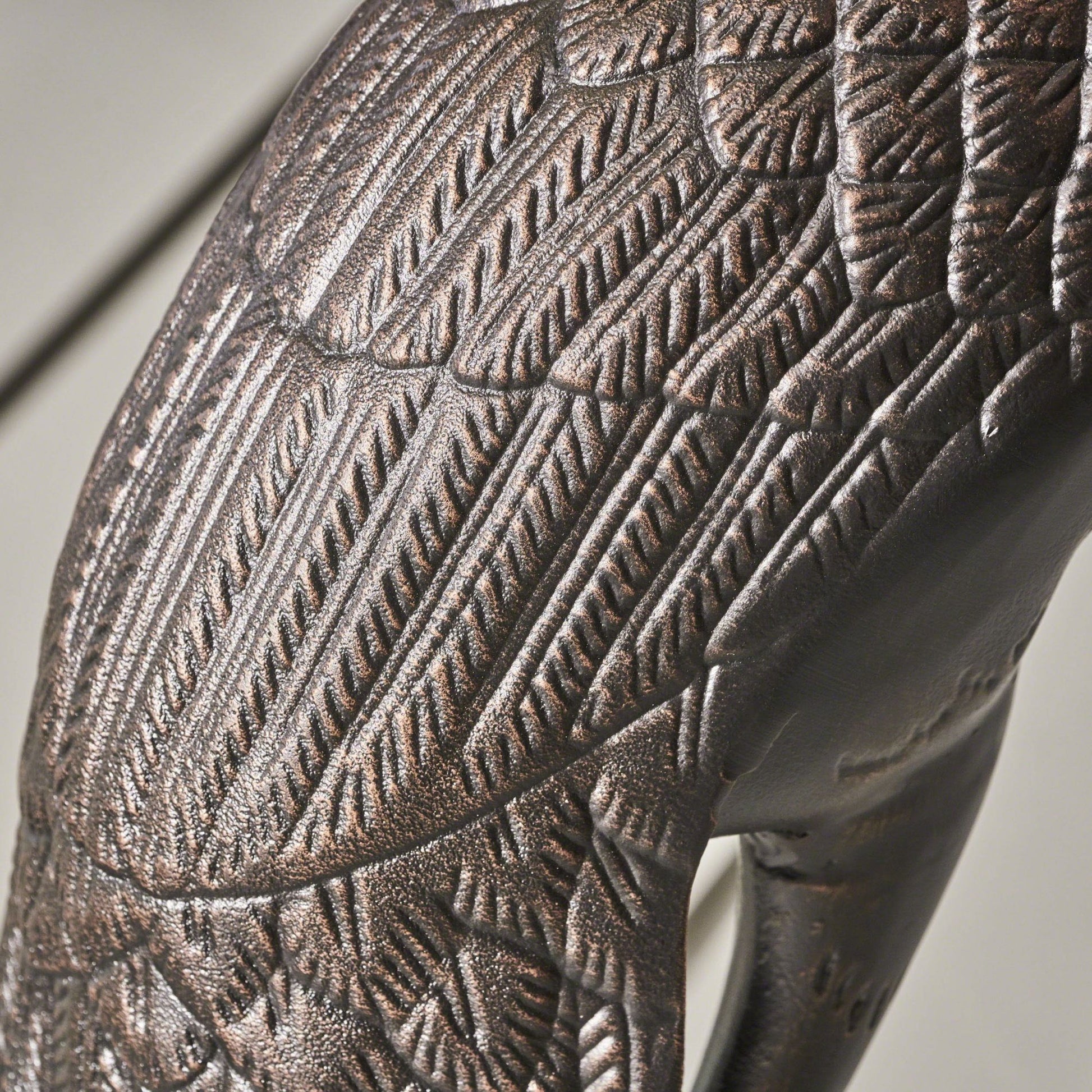 Closeup of textured bronze eagle wing detail showcasing realistic feather design for outdoor decor