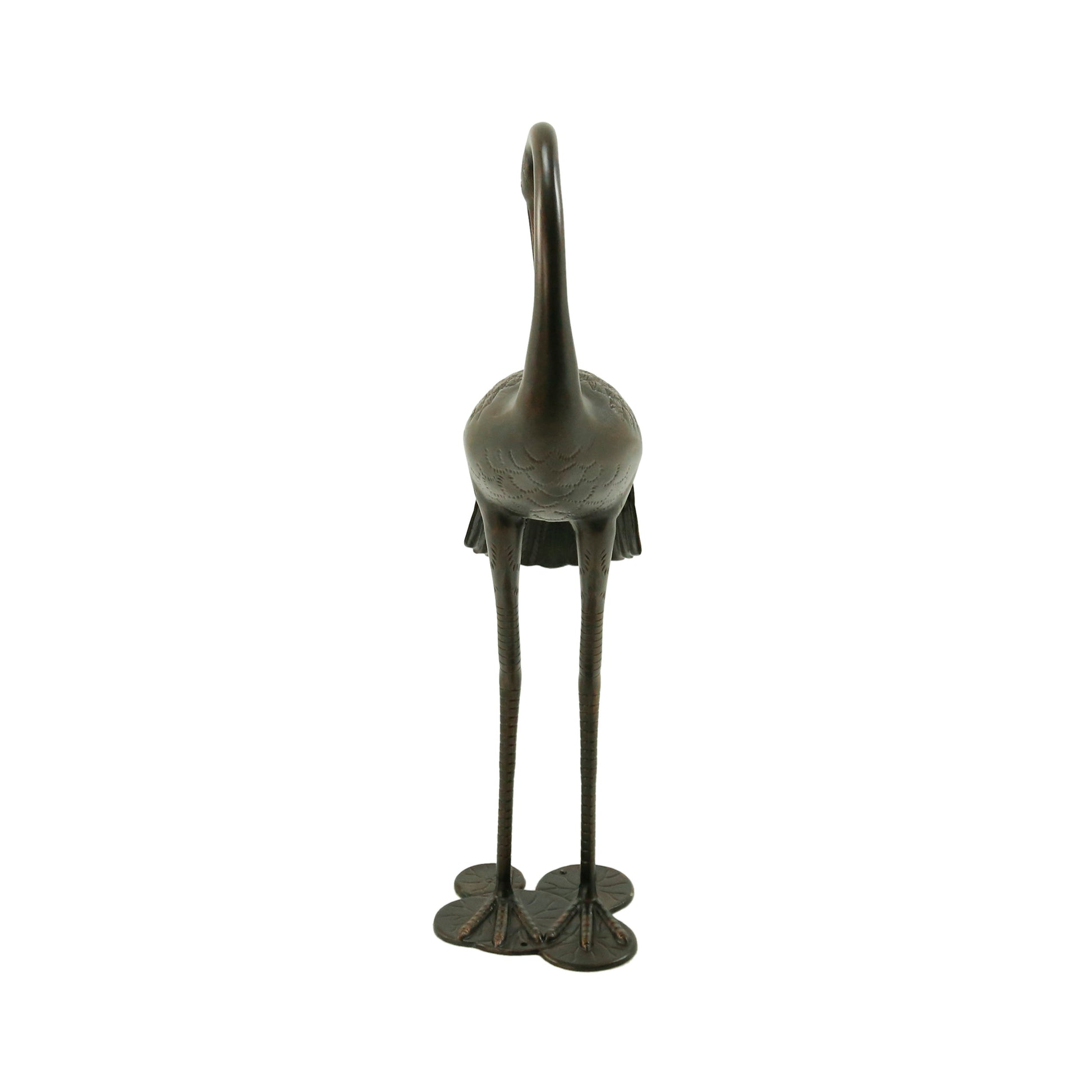 Bronze crane statue with intricate feather details and long legs standing on a decorative base