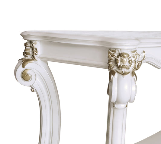 Ornate white console table with gold accents and carved details