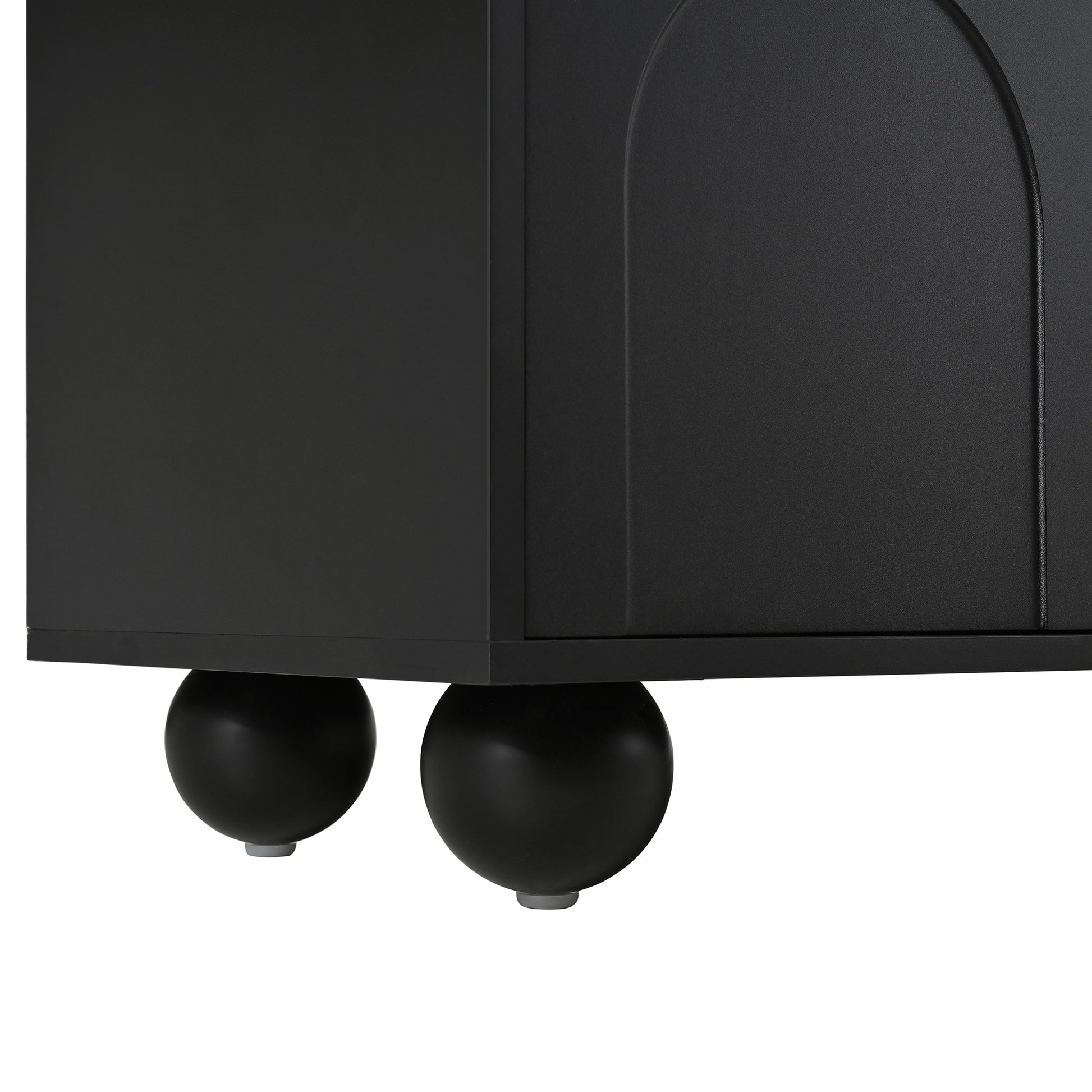 Black cabinet with curved door detail and rounded spherical legs