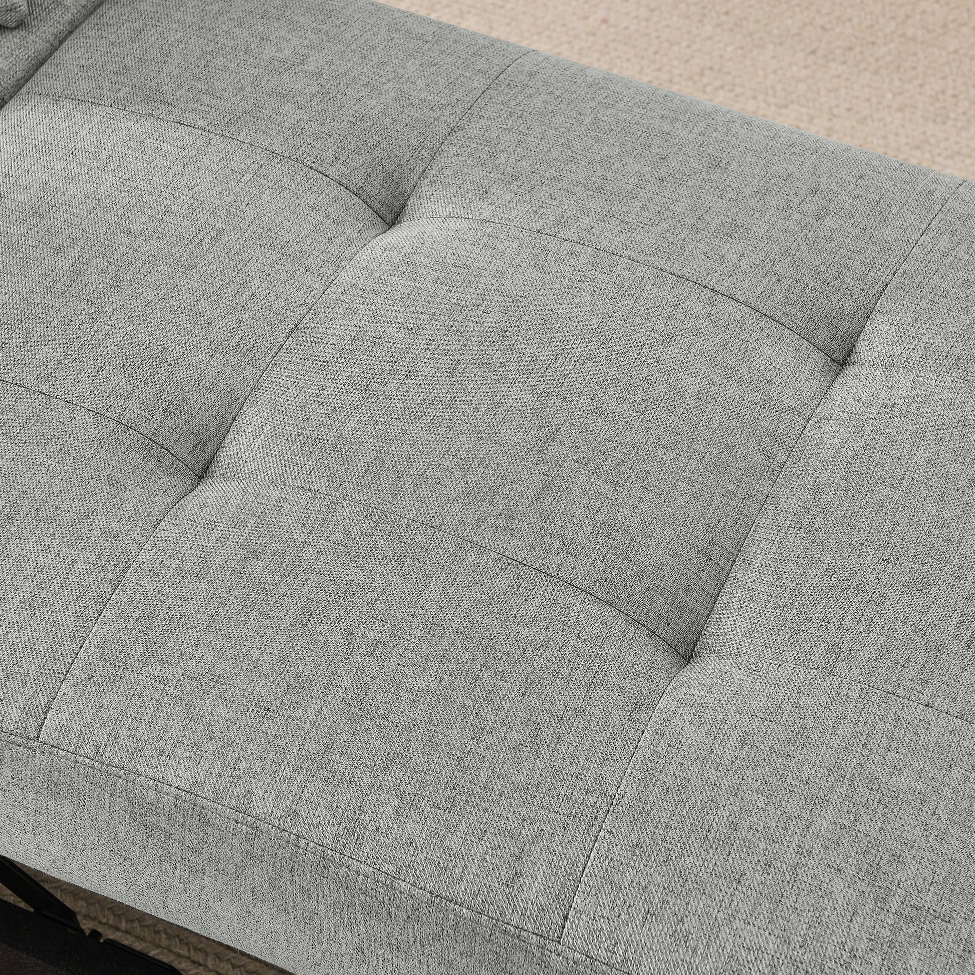 Closeup of a grey textured fabric bench seat with diamond tufting for modern decor
