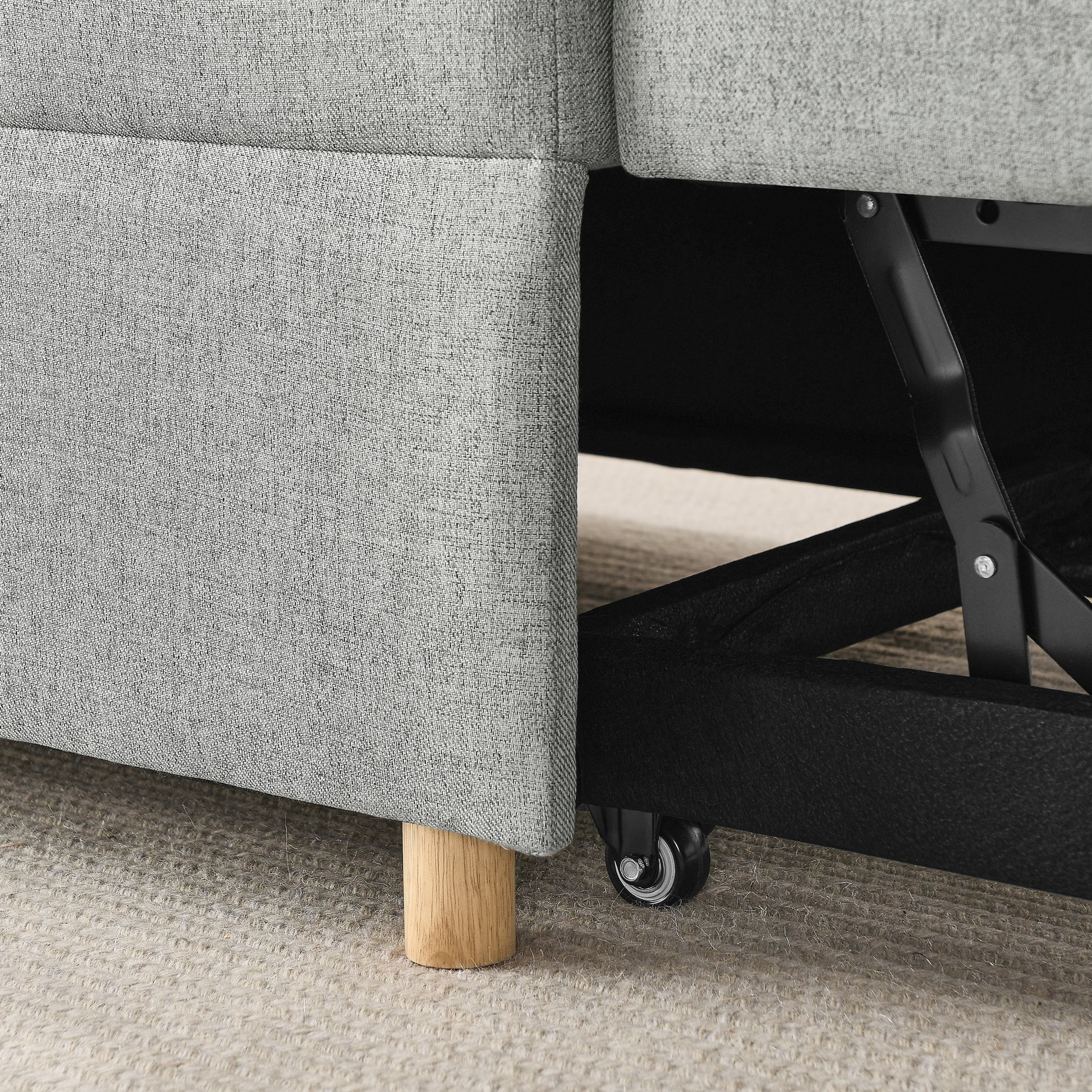 Gray fabric sofa base with wooden leg and rolling caster wheel for easy mobility