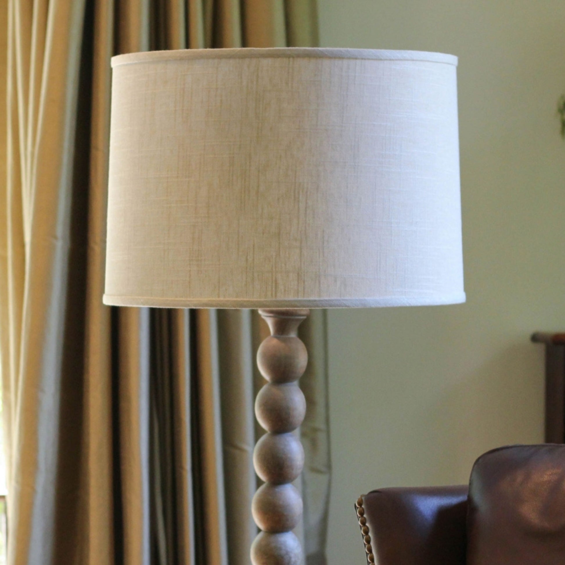Cream linen drum lampshade with a wooden stacked ball base accent lamp
