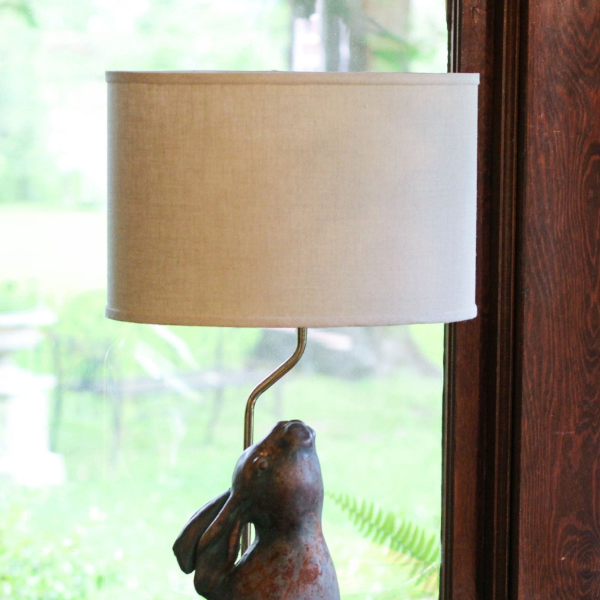 Bronze rabbit table lamp with a textured natural linen shade  chars