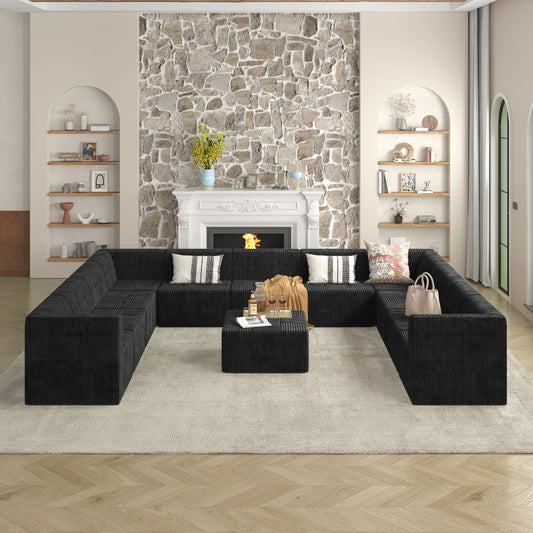 Spacious black corduroy sectional sofa with matching ottoman for a modern living room