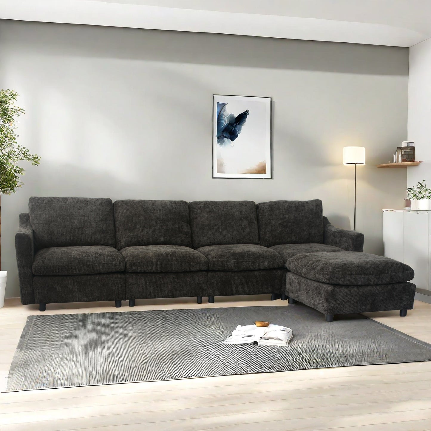 Dark charcoal fabric sectional sofa with chaise lounge on a grey rug