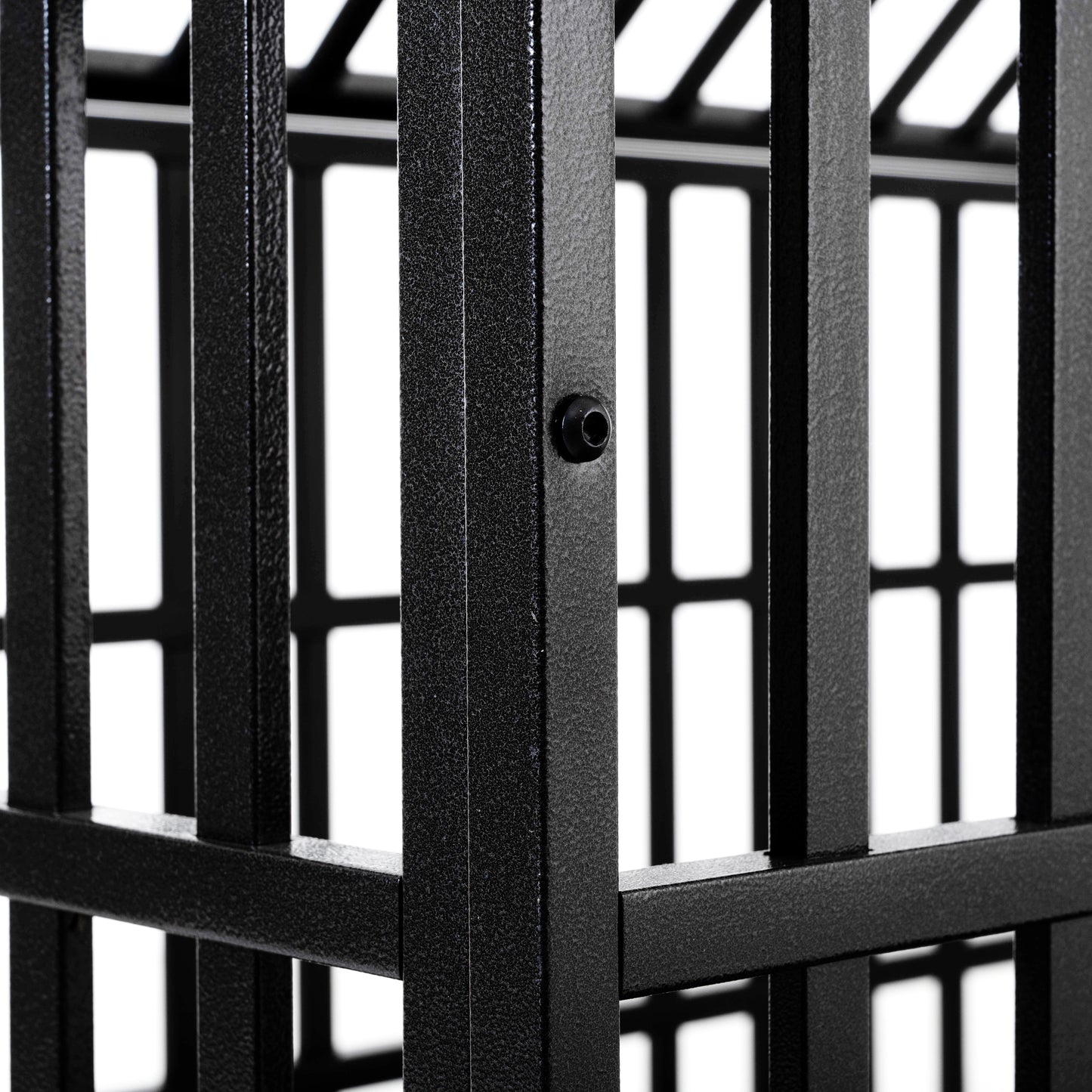 Closeup of textured black metal frame part of a dog crate